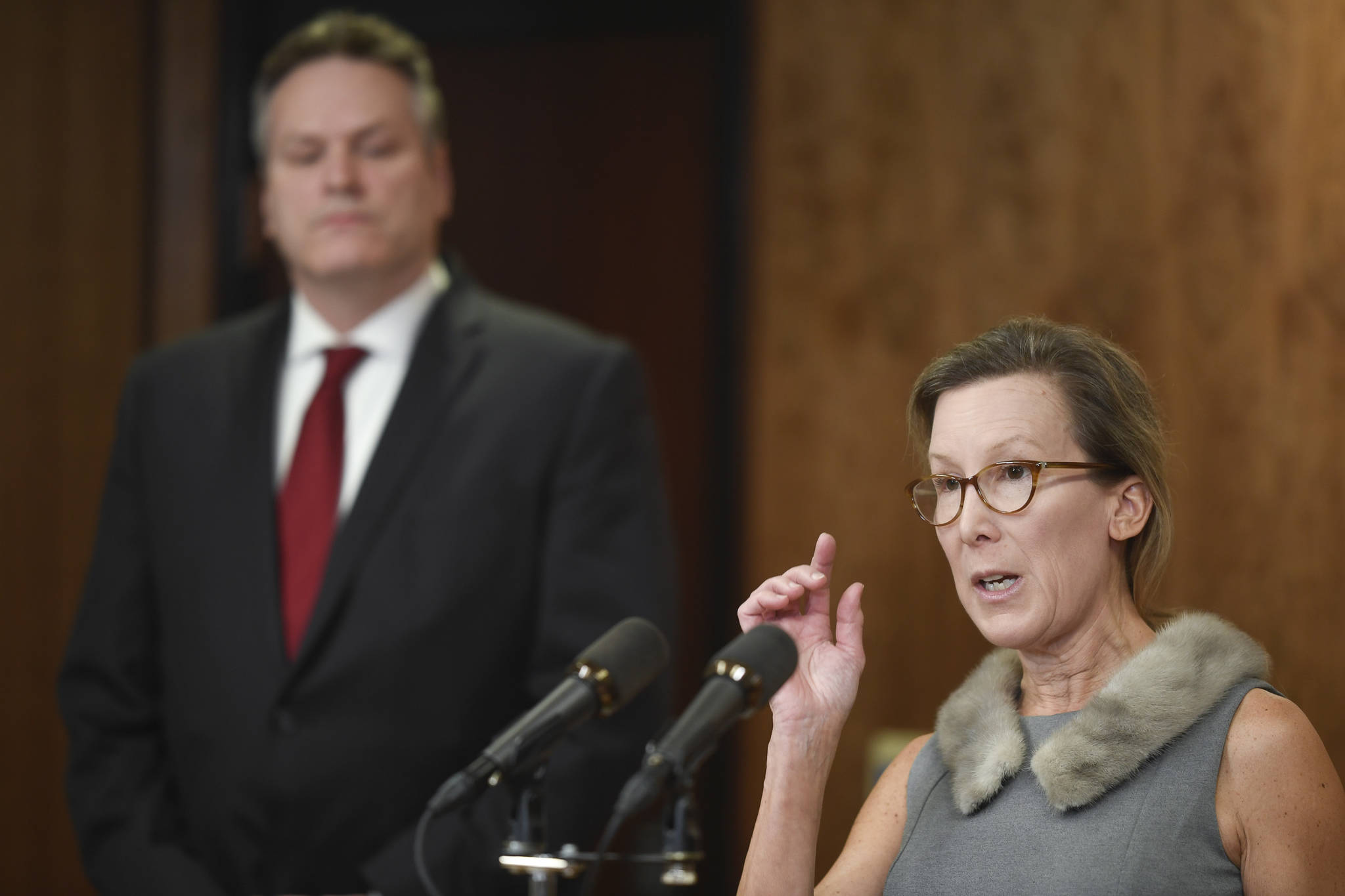 In this Feb. 13, 2019 photo, Office of Management and Budget Director Donna Arduin explains the budget as Gov. Mike Dunleavy listens during a press conference. (Michael Penn | Juneau Empire File)