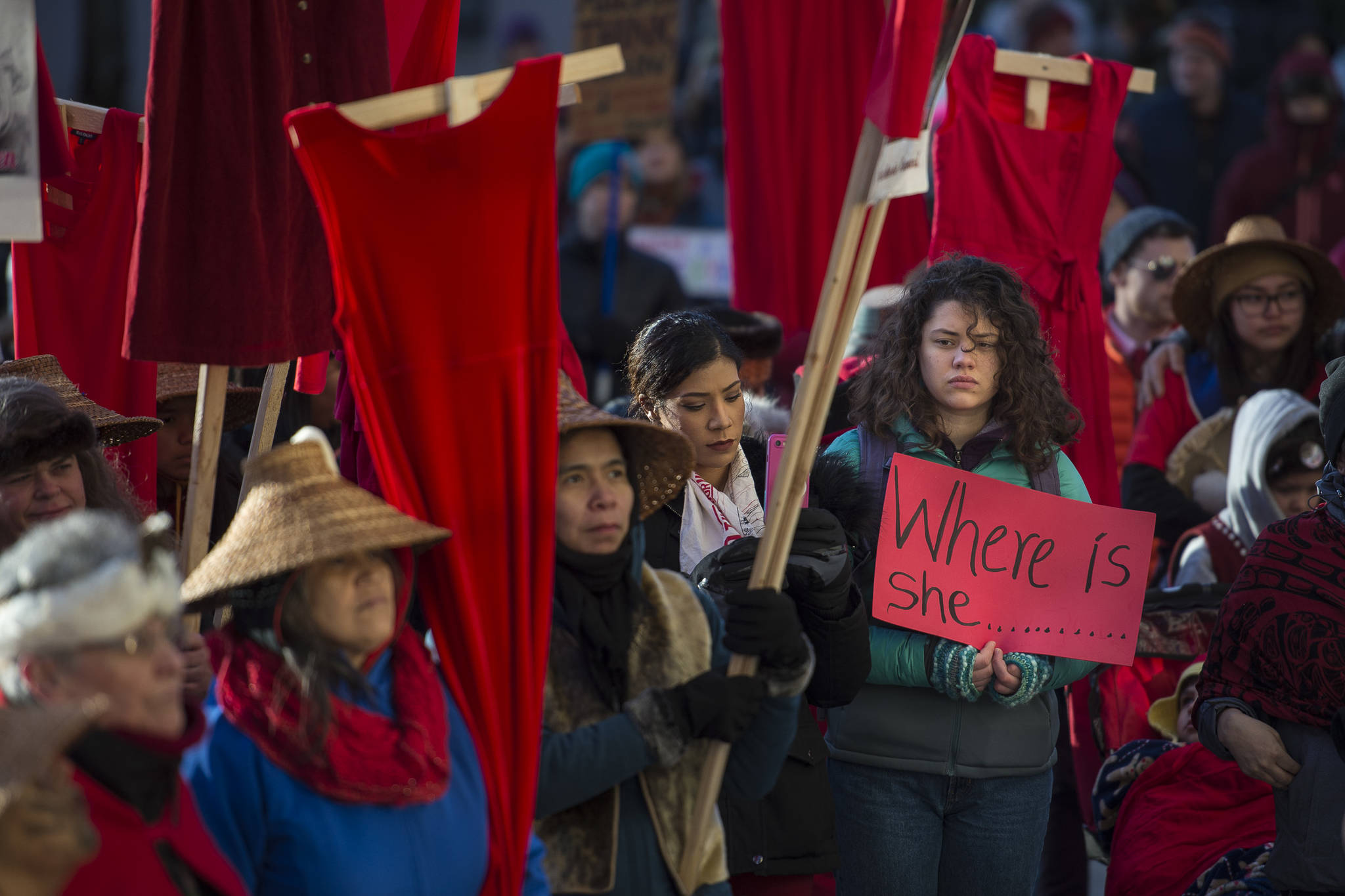 Native women hold up red dresses to symbolize missing and murdered indigenous women during the Women’s March on Juneau in front of the Alaska State Capitol on Saturday, Jan. 19, 2019. (Michael Penn | Juneau Empire)