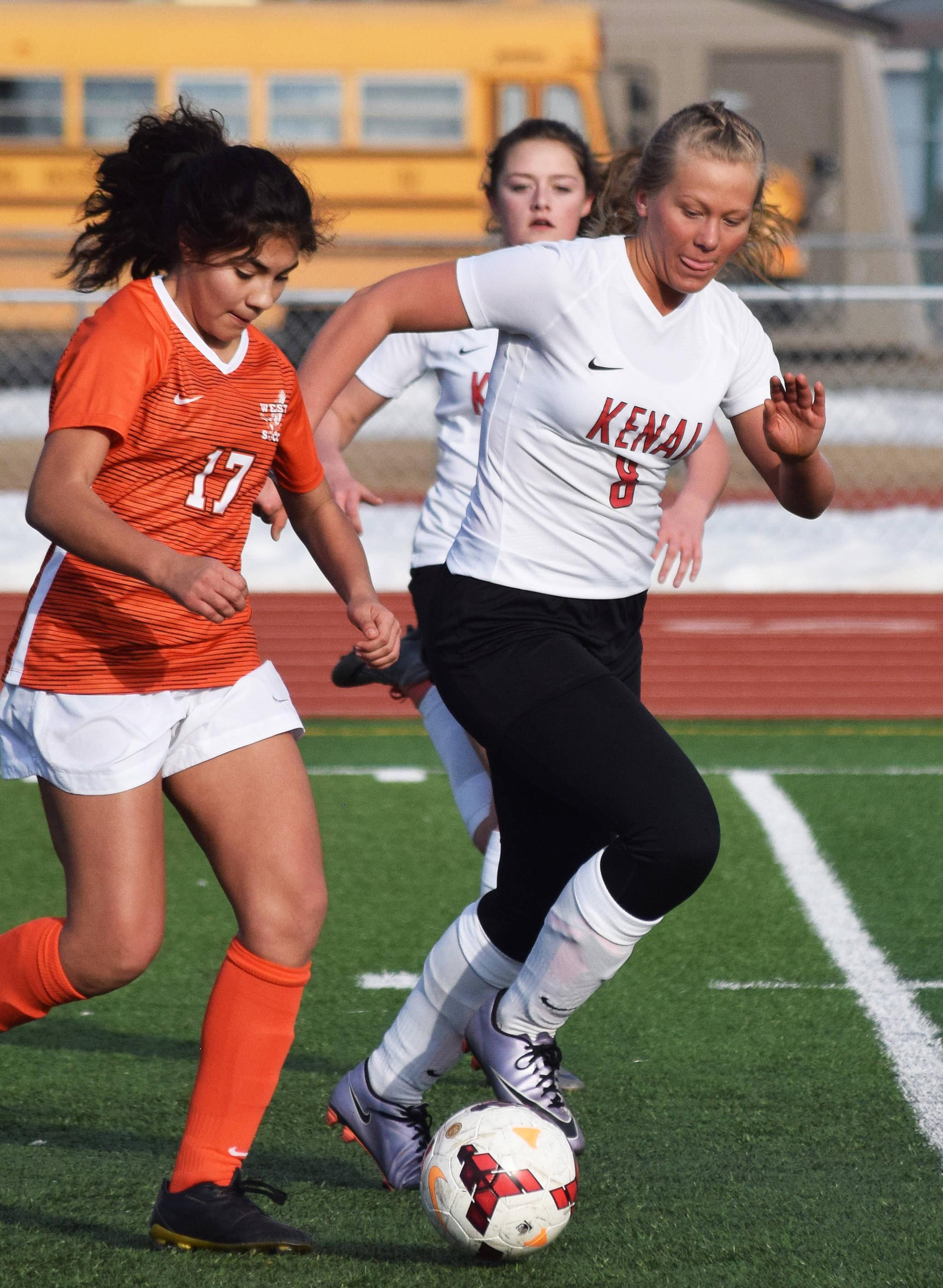 Kenai’s Anya Danielson (right) battles for possession with West’s Xaofeil Metcalf Thursday, April 4, 2019, in a nonconference game at Kenai Central High School. (Photo by Joey Klecka/Peninsula Clarion)