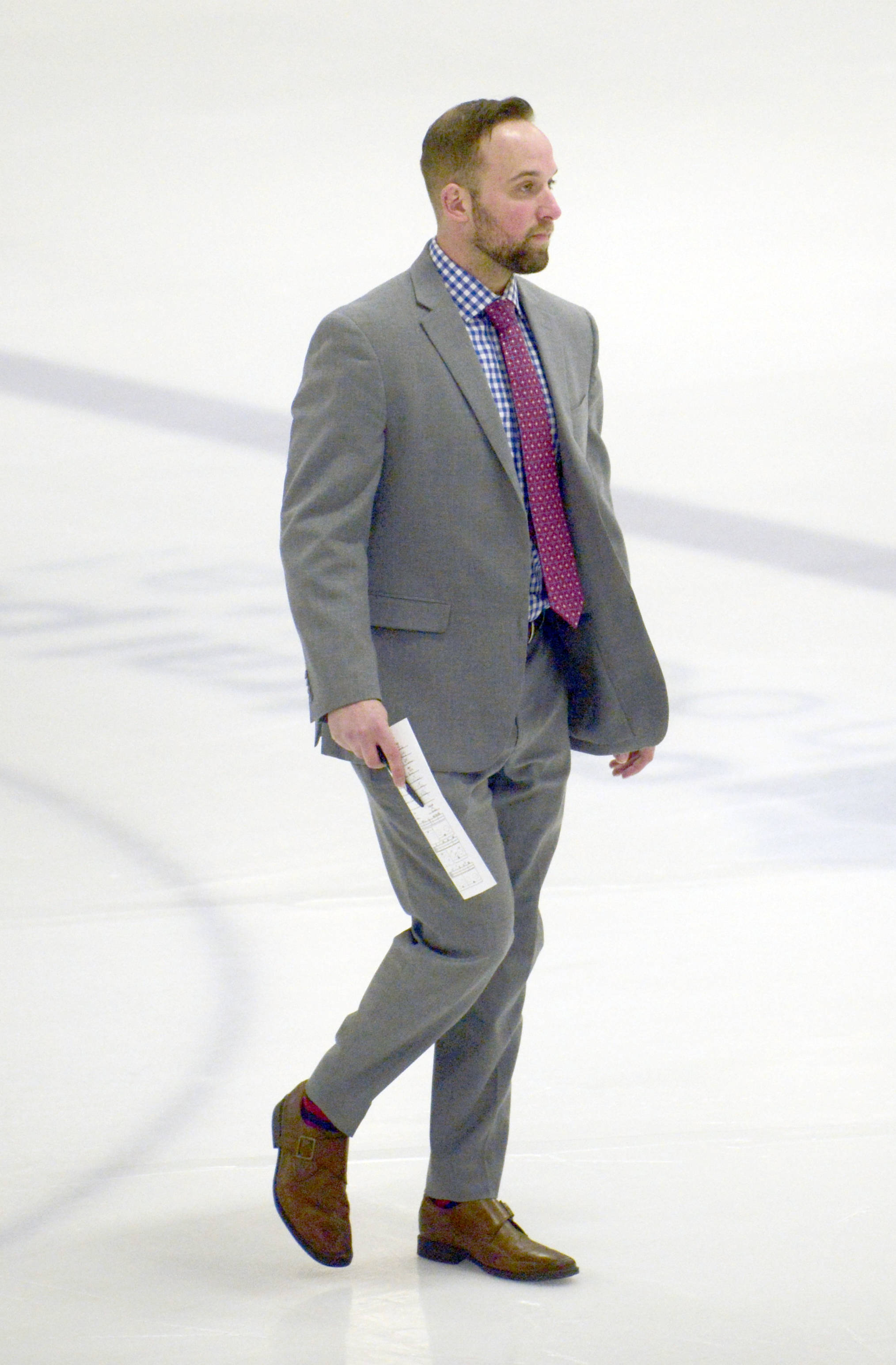 Interim head coach Dan Bogdan walks to the bench before a game March 21, 2019, against the Fairbanks Ice Dogs at the Soldotna Regional Sports Complex. (Photo by Jeff Helminiak/Peninsula Clarion)