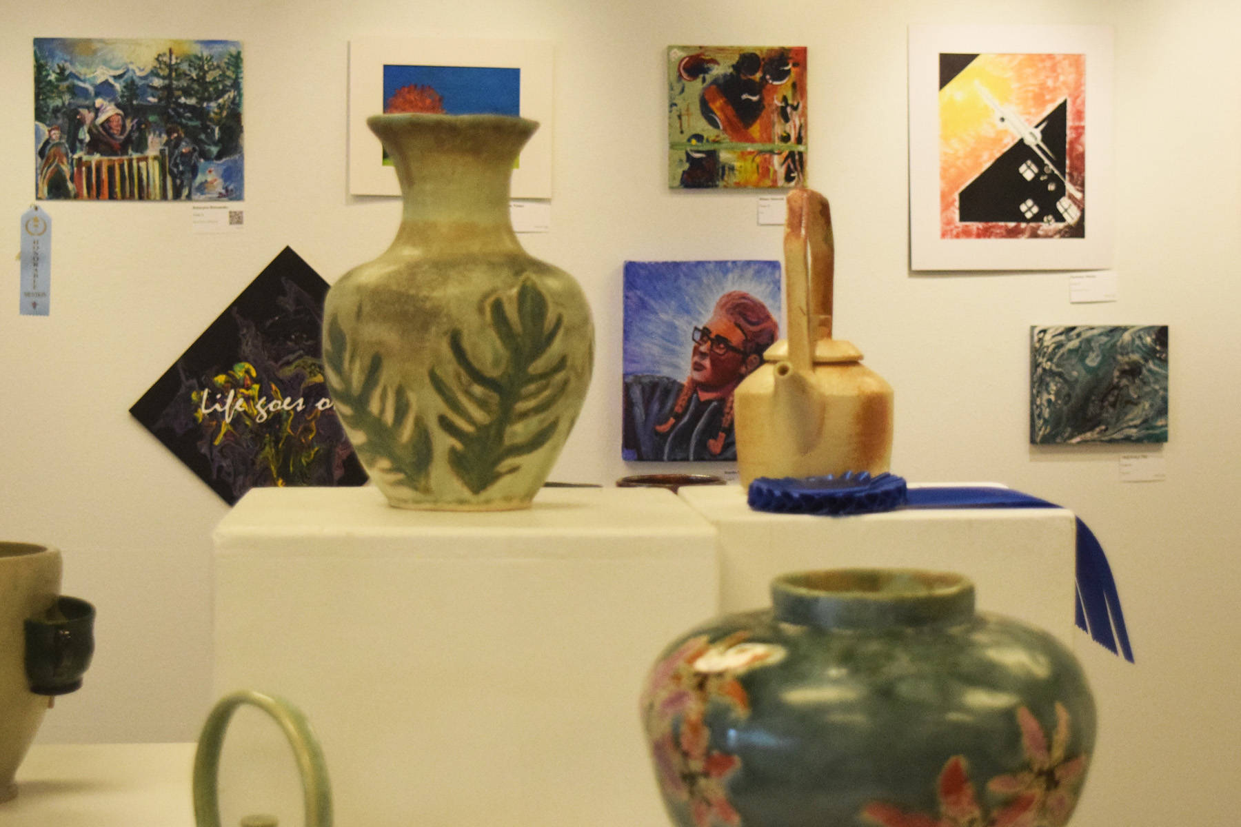 Art pieces are on display at the Kenai Fine Arts Center during Thursday’s opening reception of the 30th anniversary Visual Feast art show. (Photo by Joey Klecka/Peninsula Clarion)