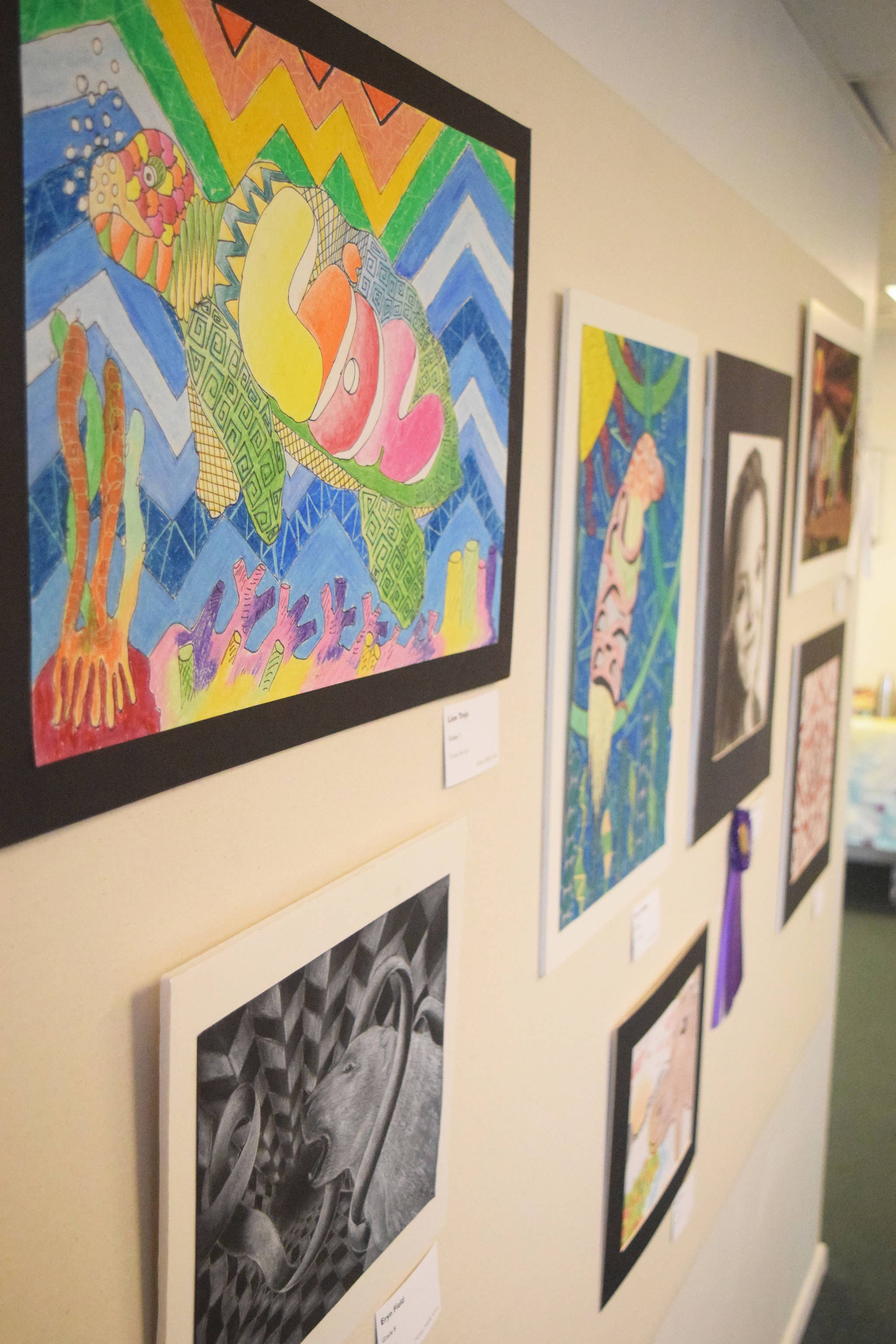 Art pieces hang in the middle school gallery during Thursday’s opening reception of the 30th anniversary Visual Feast art show. (Photo by Joey Klecka/Peninsula Clarion)