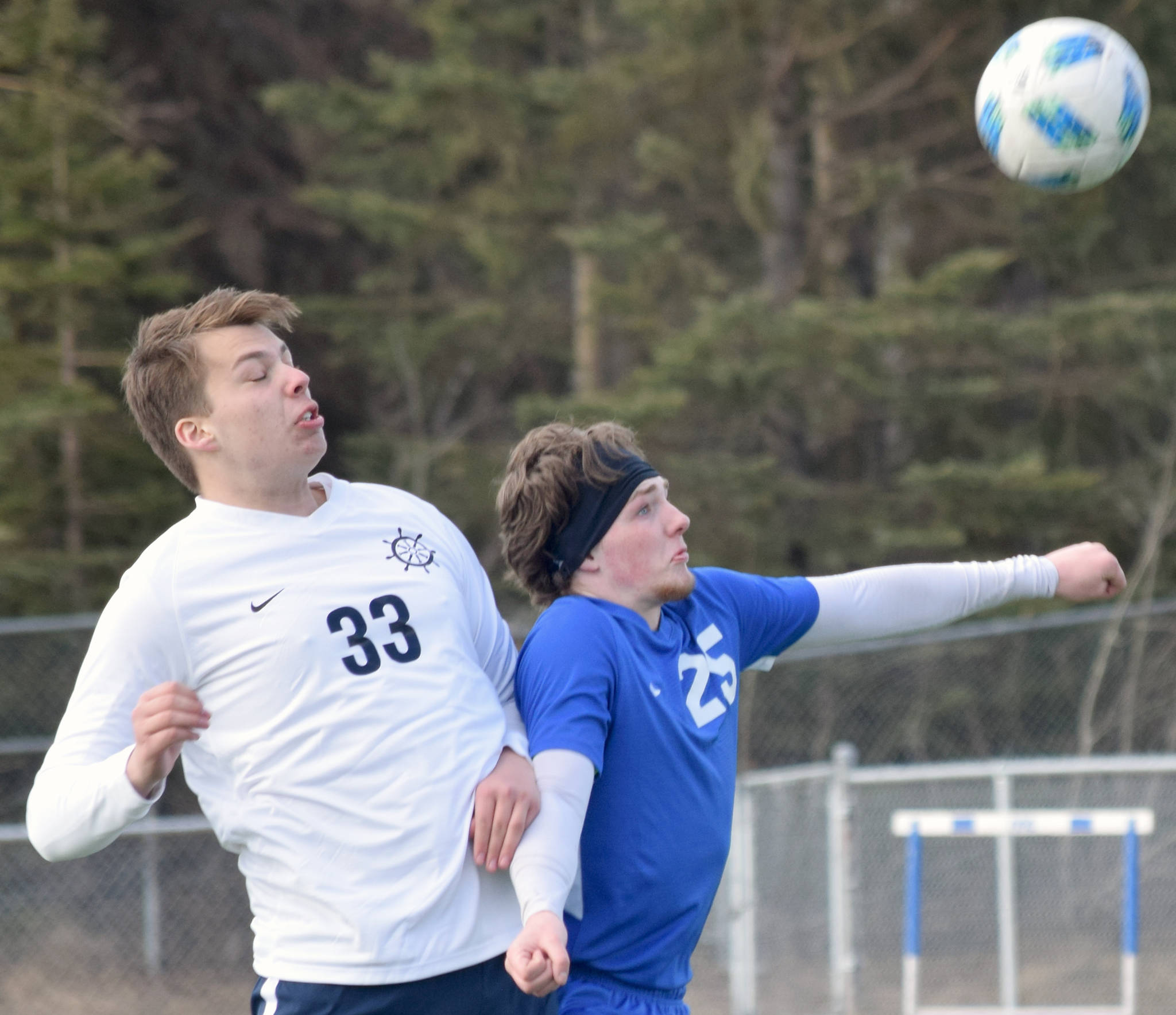 Homer’s Henry Russell and Soldotna’s Cameron Johnson battle for the ball Tuesday at Soldotna High School in Soldotna. (Photo by Jeff Helminiak/Peninsula Clarion)