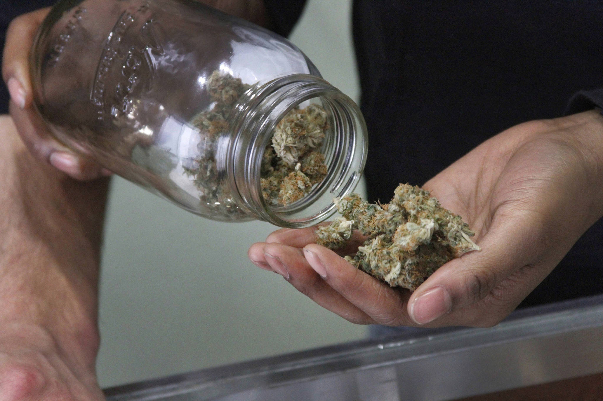 In this Feb. 20, 2015 photo, Alaska Cannabis Club CEO Charlo Greene prepares to roll a joint at the medical marijuana dispensary in Anchorage, Alaska. (Mark Thiessen | Associated Press File)