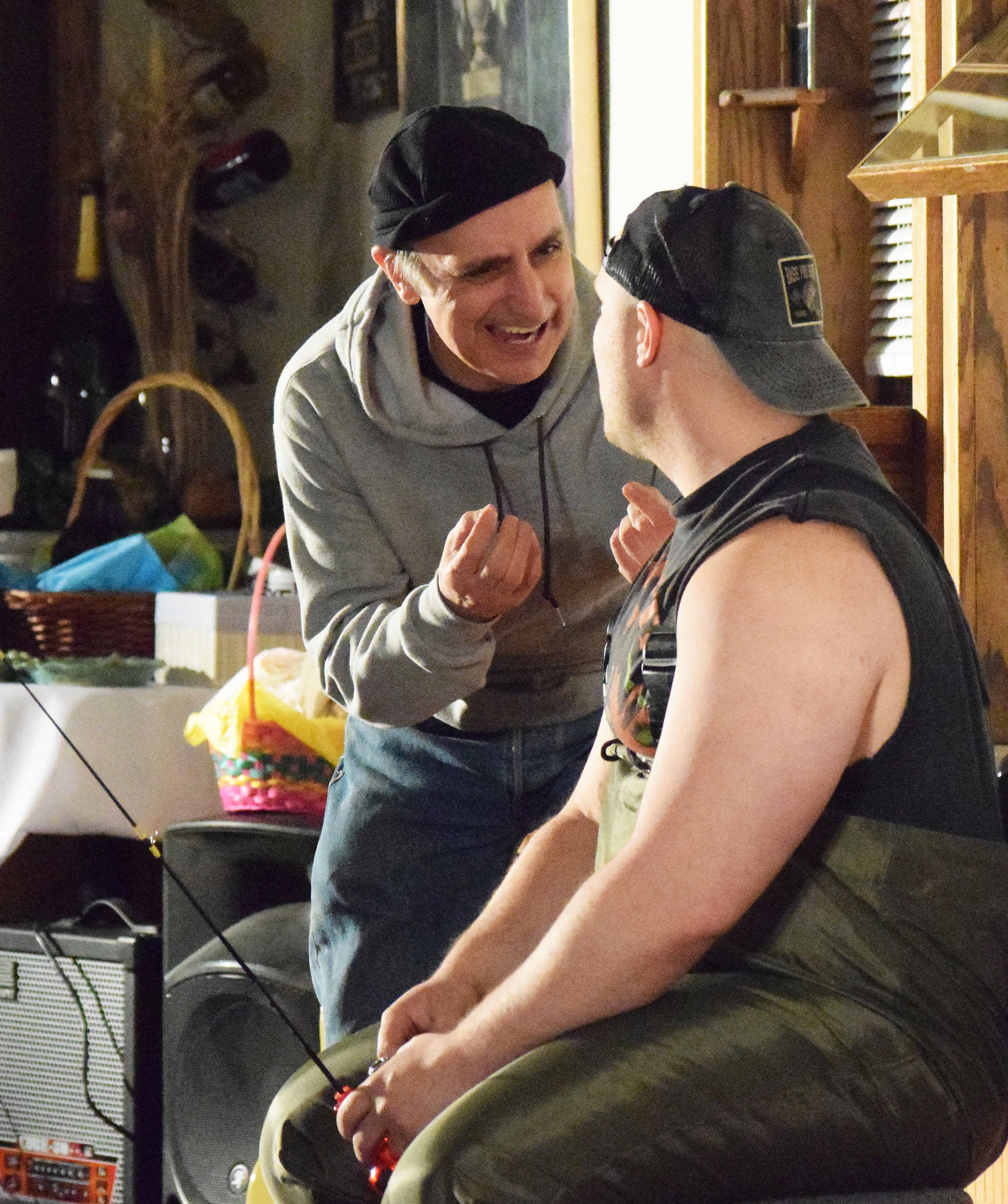 Joe Rizzo (left) acts out a scene with Tyler Payment during Triumvirant’s dinner theatre production of “Sockeye Balboa” Friday, April 5, 2019, at Mykel’s Restaurant in Soldotna. (Photo by Joey Klecka/Peninsula Clarion)