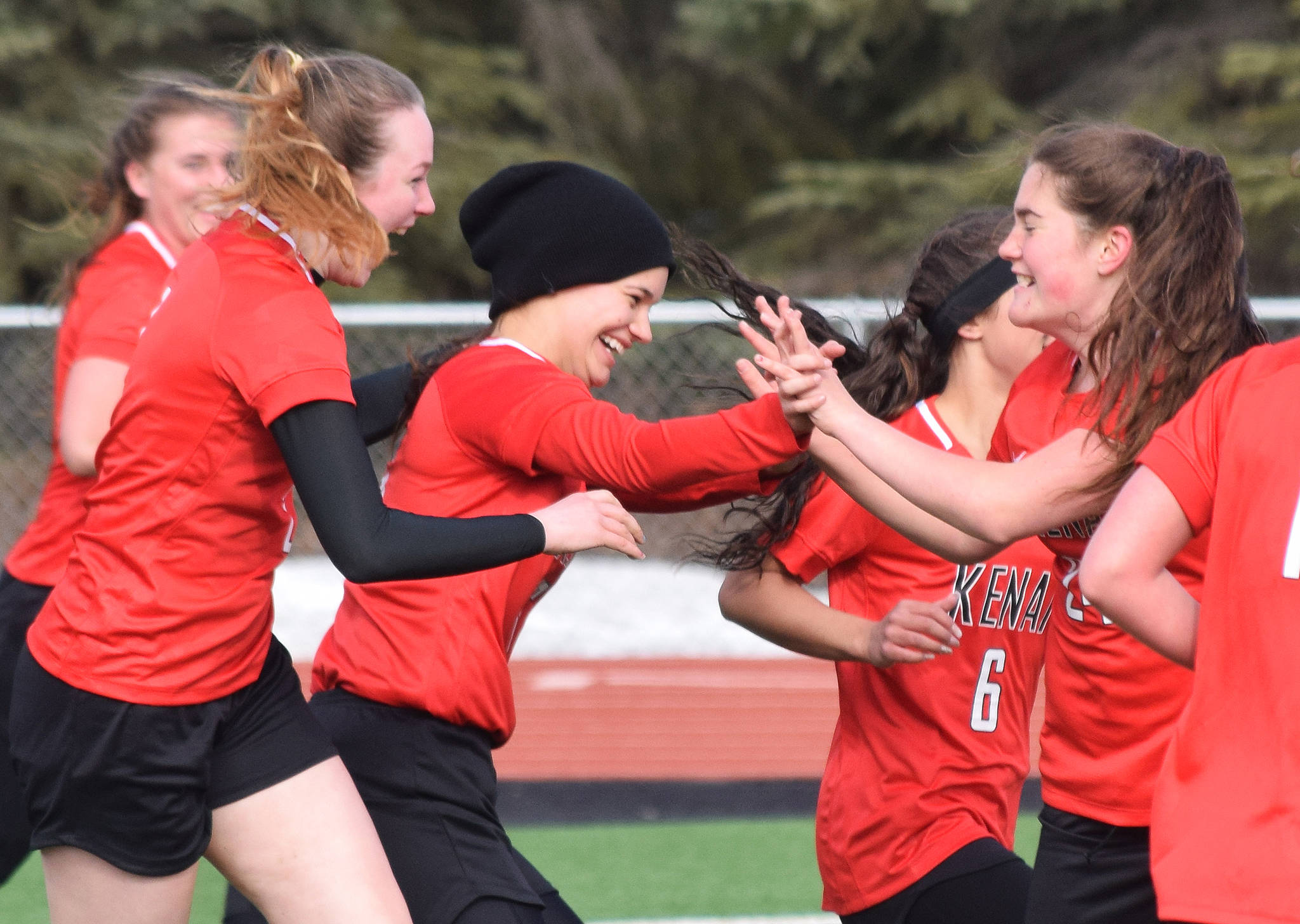 Kenai’s Taylor Pierce receives congratulations from teammates after scoring a goal Thursday against Nikiski in a Peninsula Conference clash at Kenai Central High School. (Photo by Joey Klecka/Peninsula Clarion)