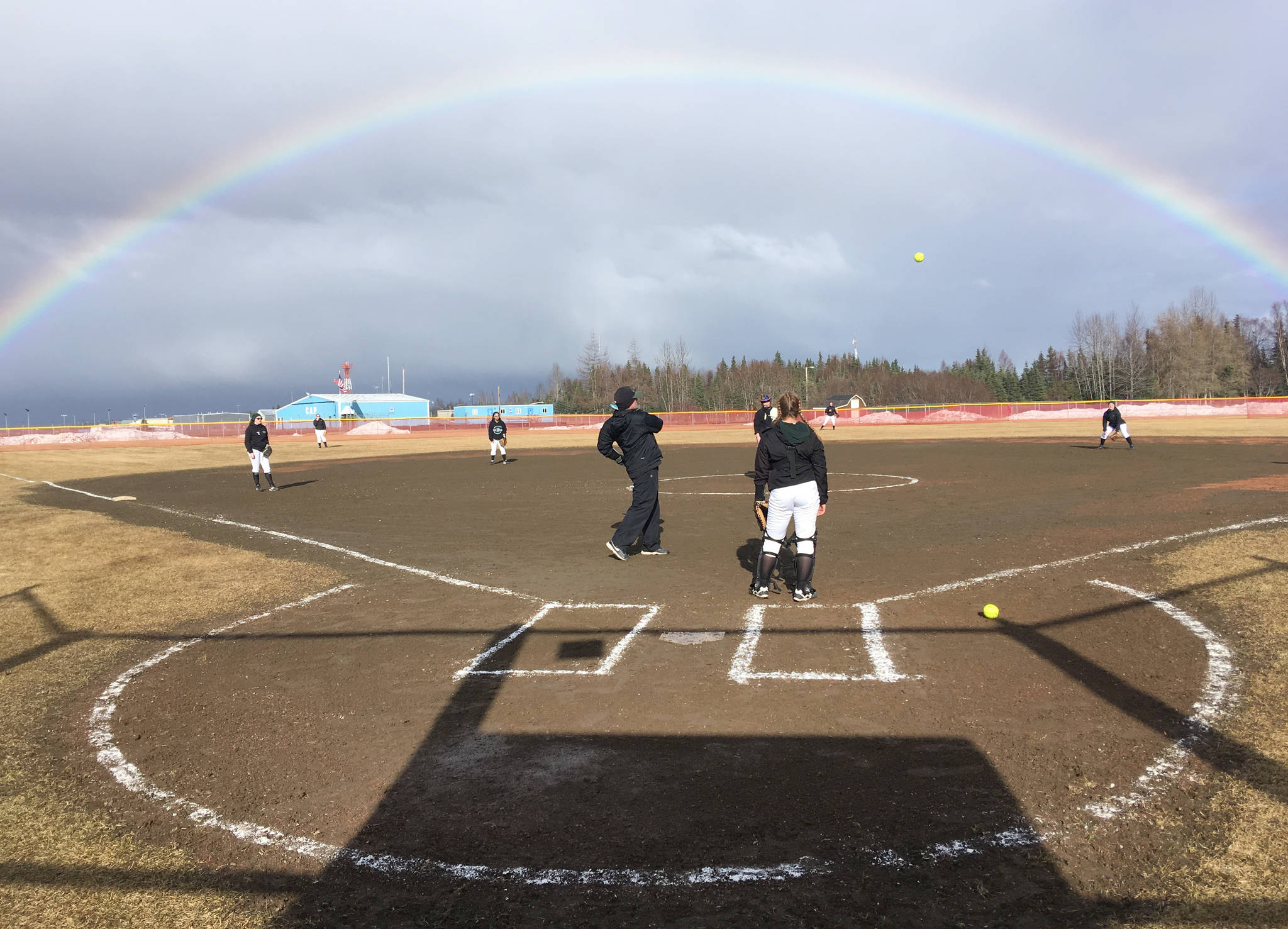 The Colony softball team warms up for a game against Kenai Central on Friday, April 12, 2019, at Steve Shearer Memorial Ball Park in Kenai, Alaska. (Photo by Jeff Helminiak/Peninsula Clarion)