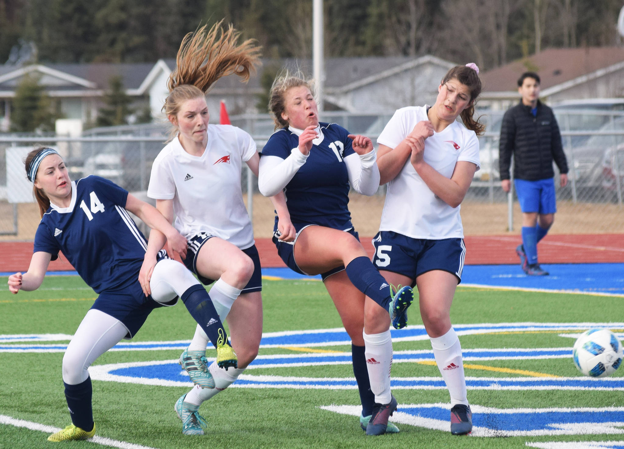 Soldotna players Kortney Birch (14) and Mykenna Foster collide with North Pole’s Breeauna O’Rear (middle left) and Mari Ana Beks, Friday, April 12, 2019, in a nonconference game at Soldotna High School. (Photo by Joey Klecka/Peninsula Clarion)