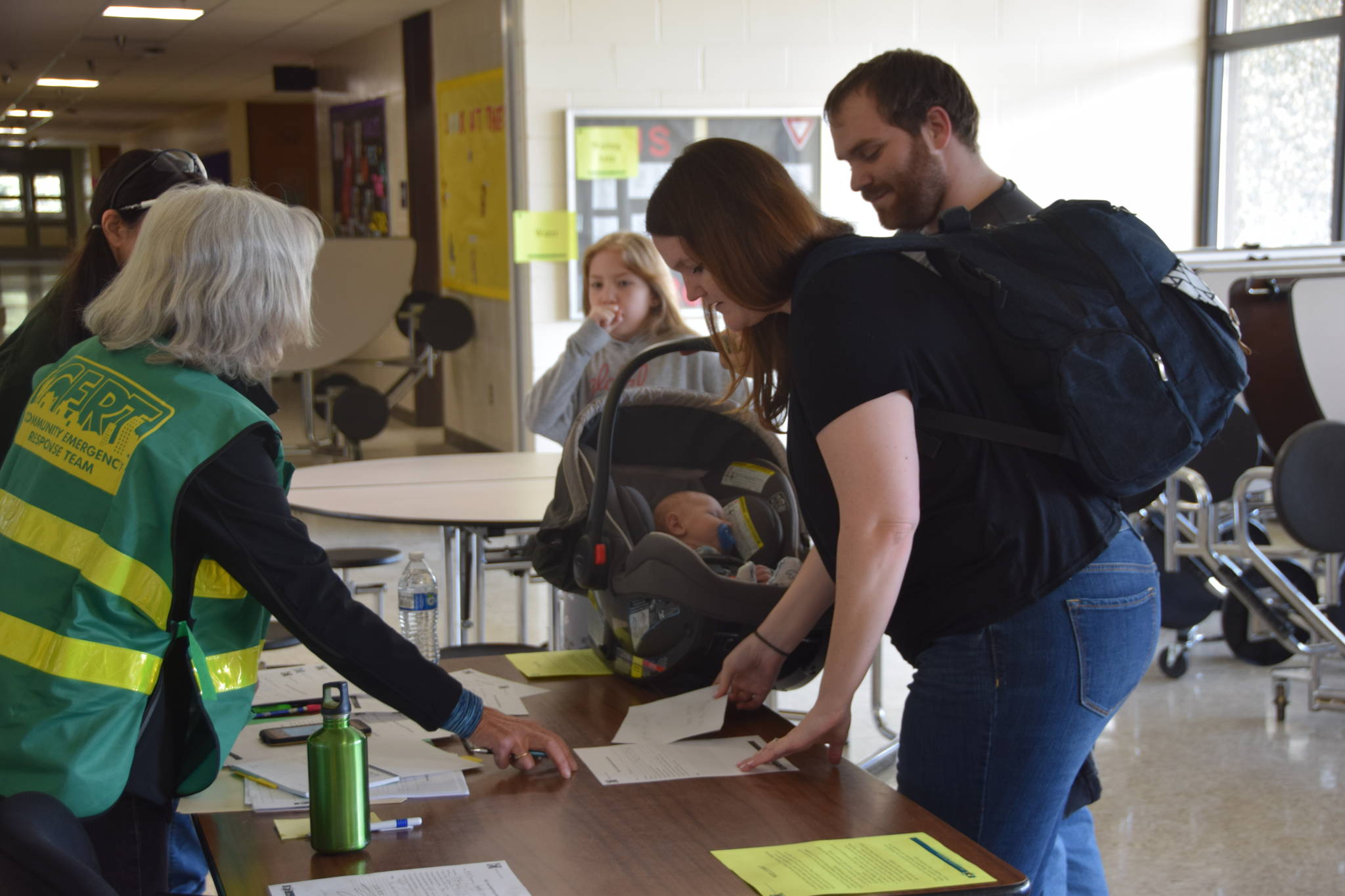 CERT Volunteers sign people in to the Disaster Help Center at Kenai Middle School in Kenai, Alaska during OEM’s Alaska Shield 2019 program on Saturday, April 13, 2019. (Photo by Brian Mazurek/Peninsula Clarion)