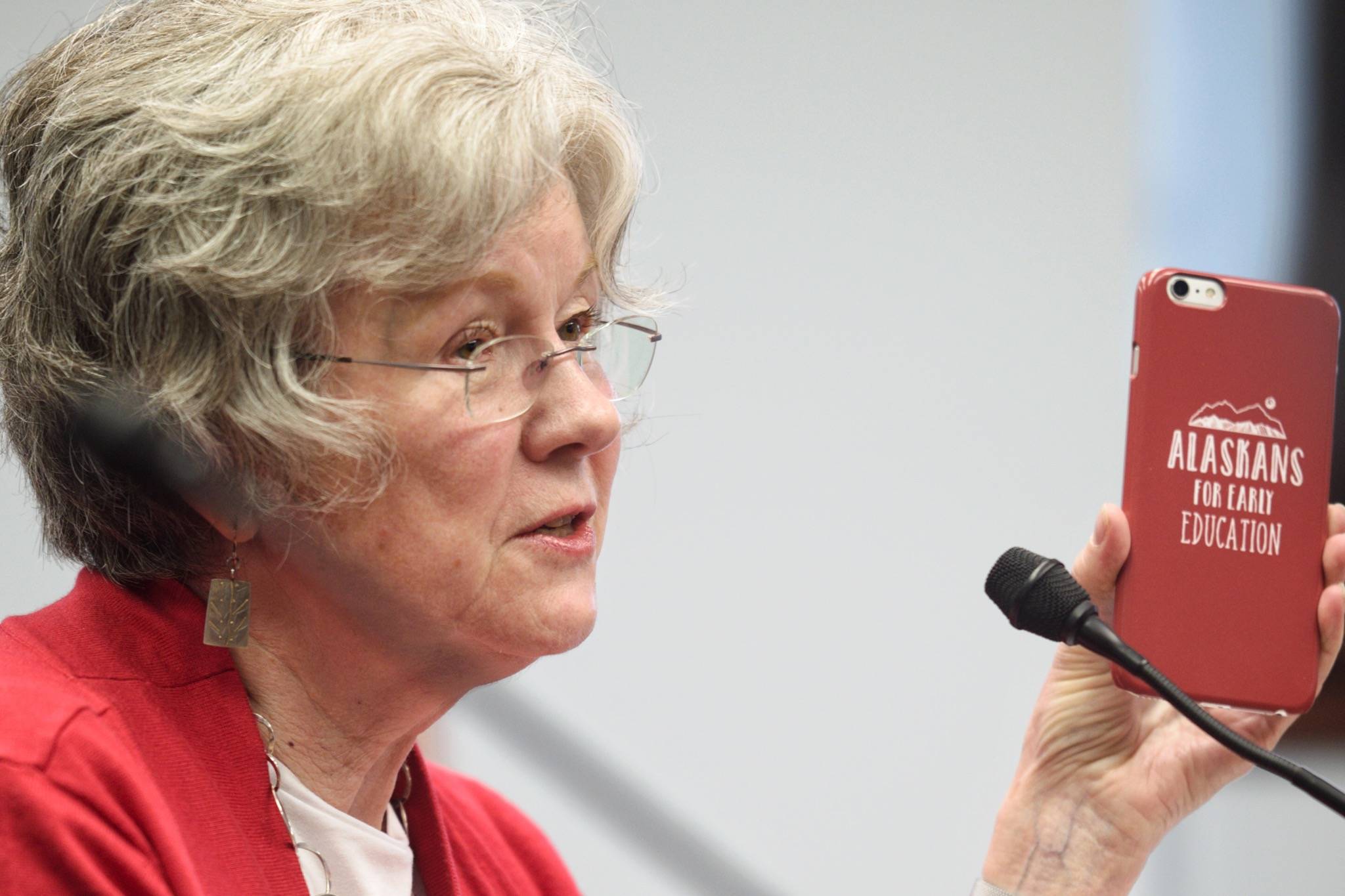 Abbe Hensley, of Best Beginnings, shows off her phone case during a hearing for SB 6 in front of the Senate Education Committee at the Capitol on Tuesday, April 16, 2019. The bill is to provide money for prekindergarten education. The case reads: Alaskans for Early Education. (Michael Penn | Juneau Empire)