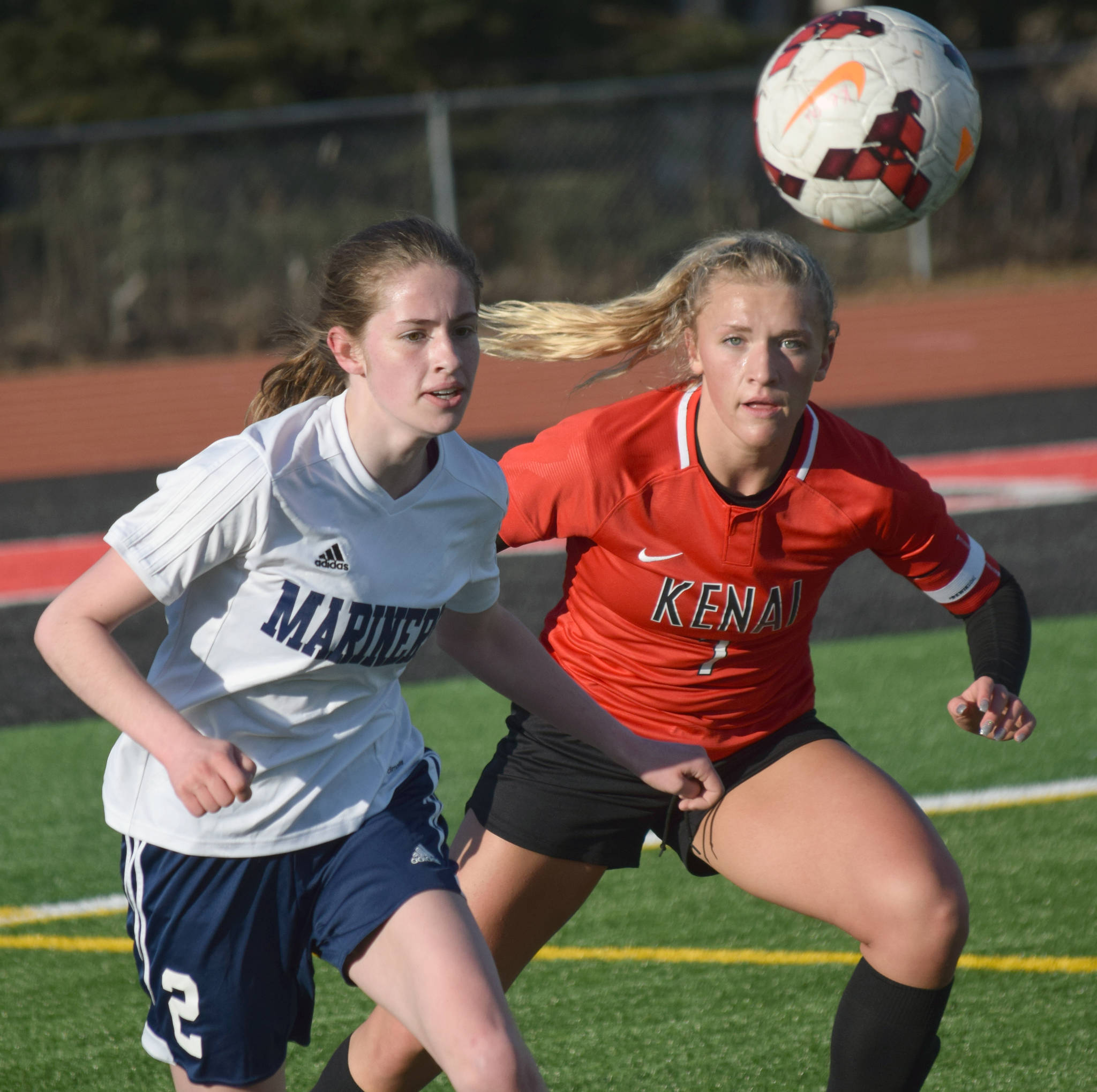 Homer’s Laura Inama and Kenai Central’s Damaris Severson battle for the ball Tuesday, April 16, 2019, at Kenai Central High School in Kenai, Alaska. (Photo by Jeff Helminiak/Peninsula Clarion)