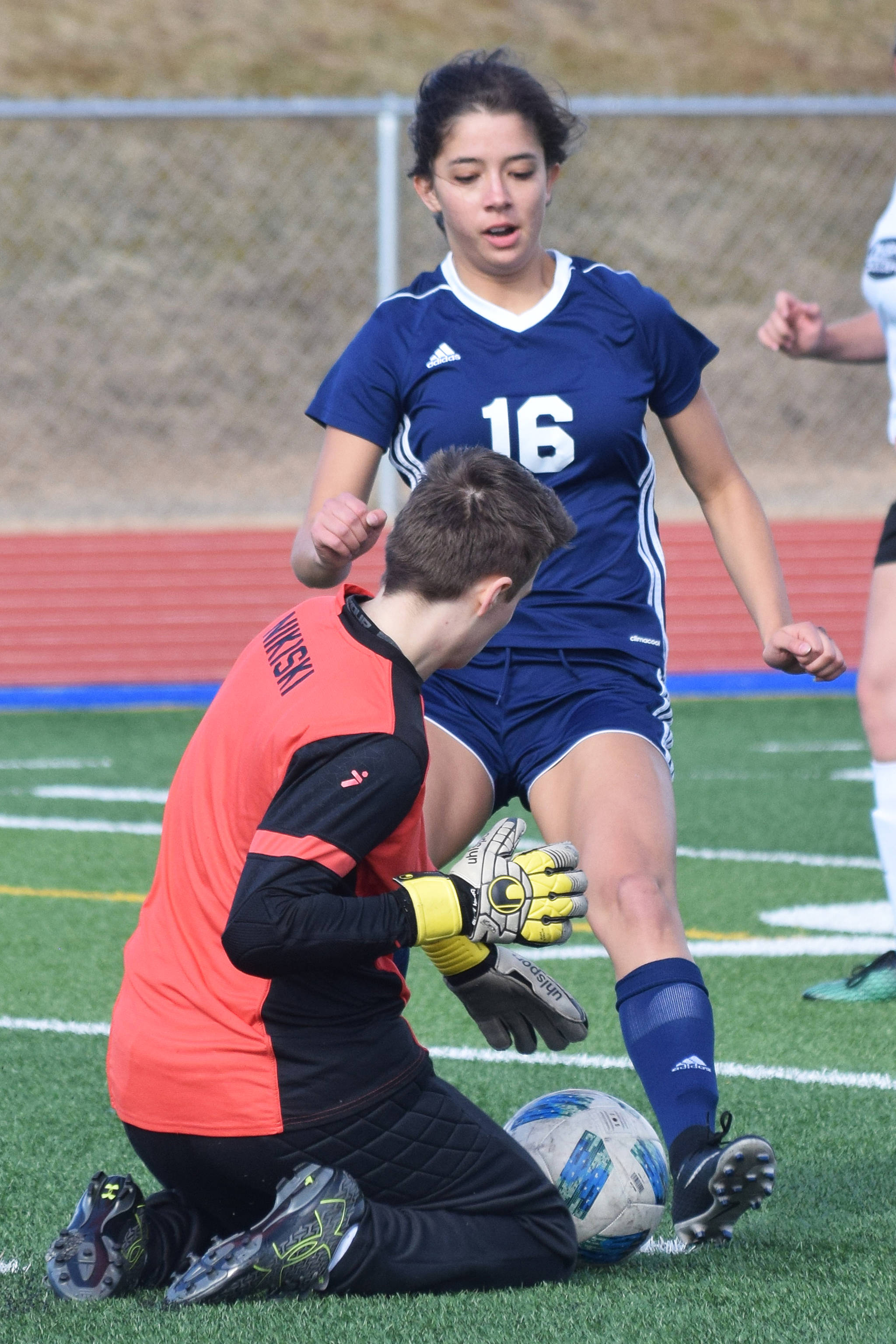 Nikiski goalkeeper Abby Bystedt dives for a save against Soldotna’s Sierra Kuntz (16) Tuesday in a Peninsula Conference game at Soldotna High School. (Photo by Joey Klecka/Peninsula Clarion)