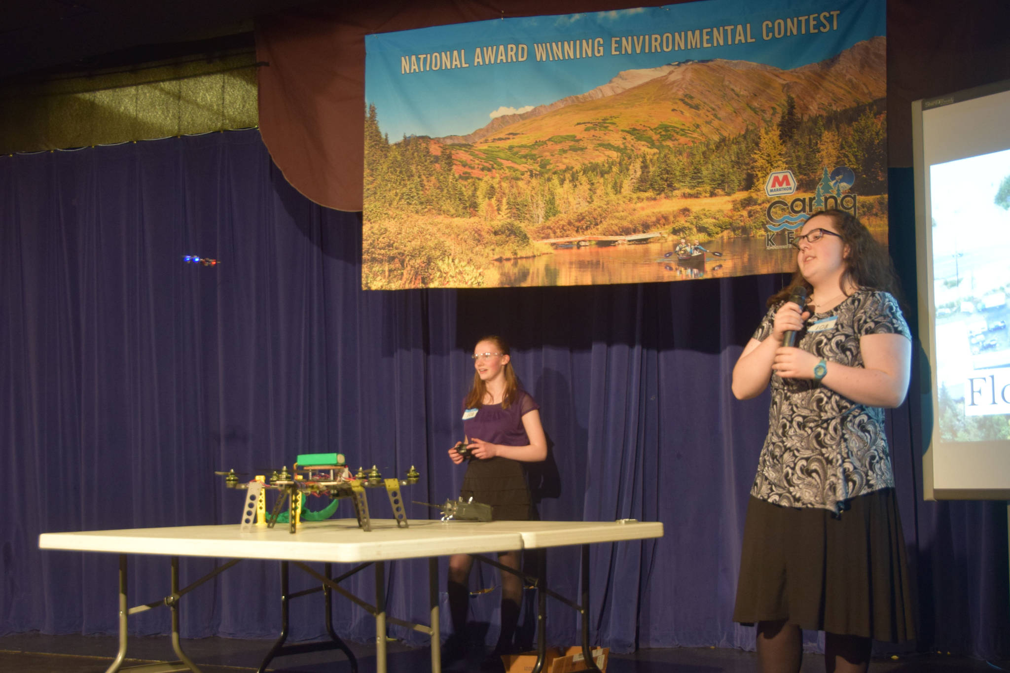Seward High School students and second-place winners Lindy Guernsey and Akilena Veach present their drone project at the Caring for the Kenai contest at Kenai Central High School in Alaska on Thursday, April 18, 2019. (Photo by Brian Mazurek/Peninsula Clarion)