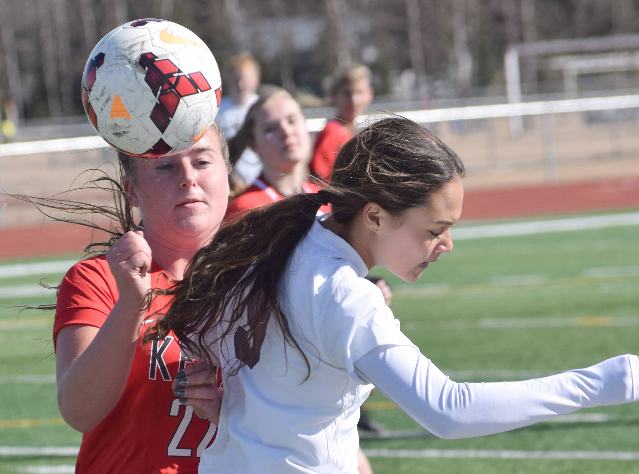 Kenai Central’s Olivia Brewer and Soldotna’s Faith Glassmaker battle for the ball Monday, April 22, 2019, at Ed Hollier Field at Kenai Central HIgh School in Kenai, Alaska. (Photo by Jeff Helminiak/Peninsula Clarion)