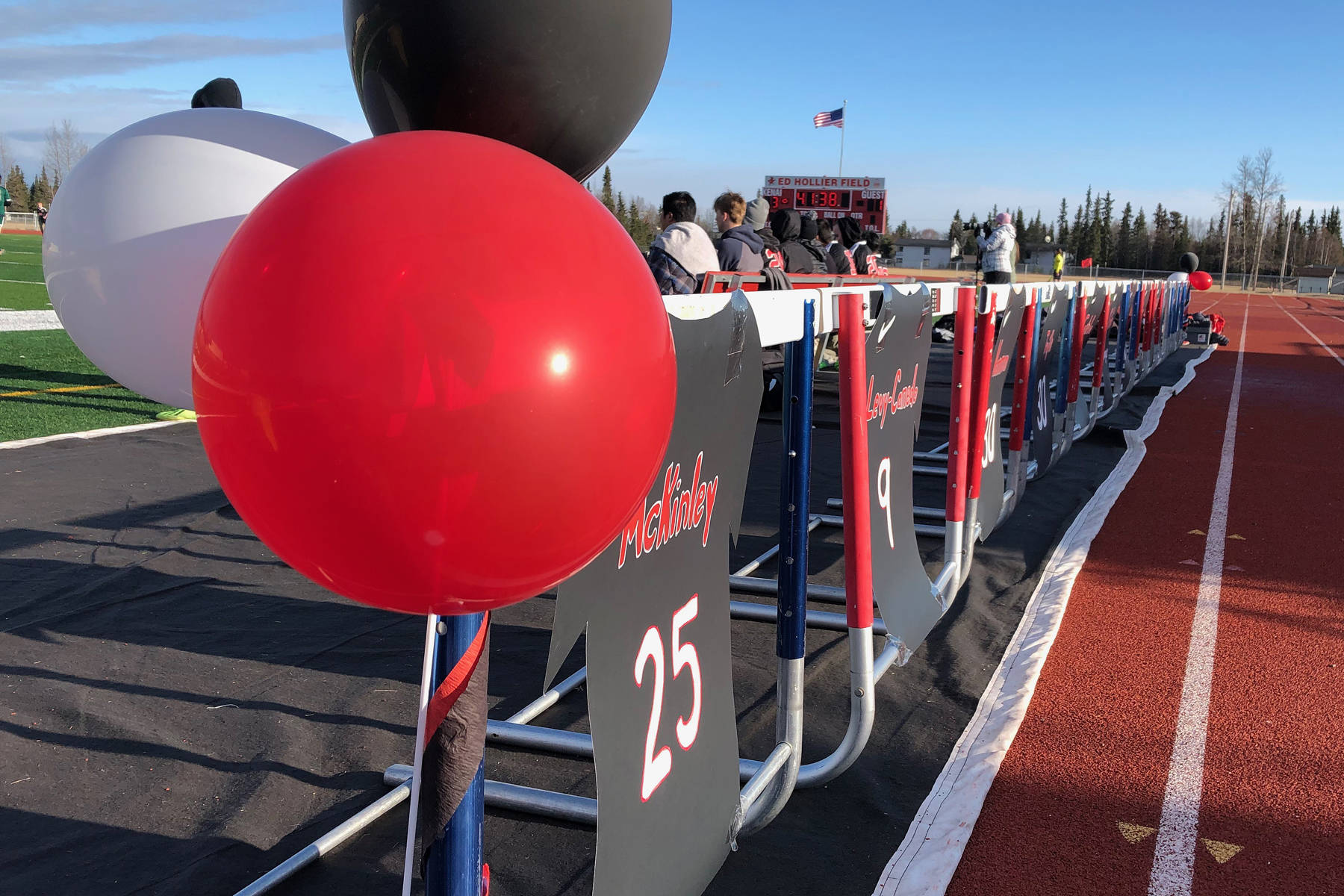 A row of handmade signs depicting the names of the senior class line the Kenai Central bench Tuesday night against Seward at Kenai Central High School. (Photo by Joey Klecka/Peninsula Clarion)