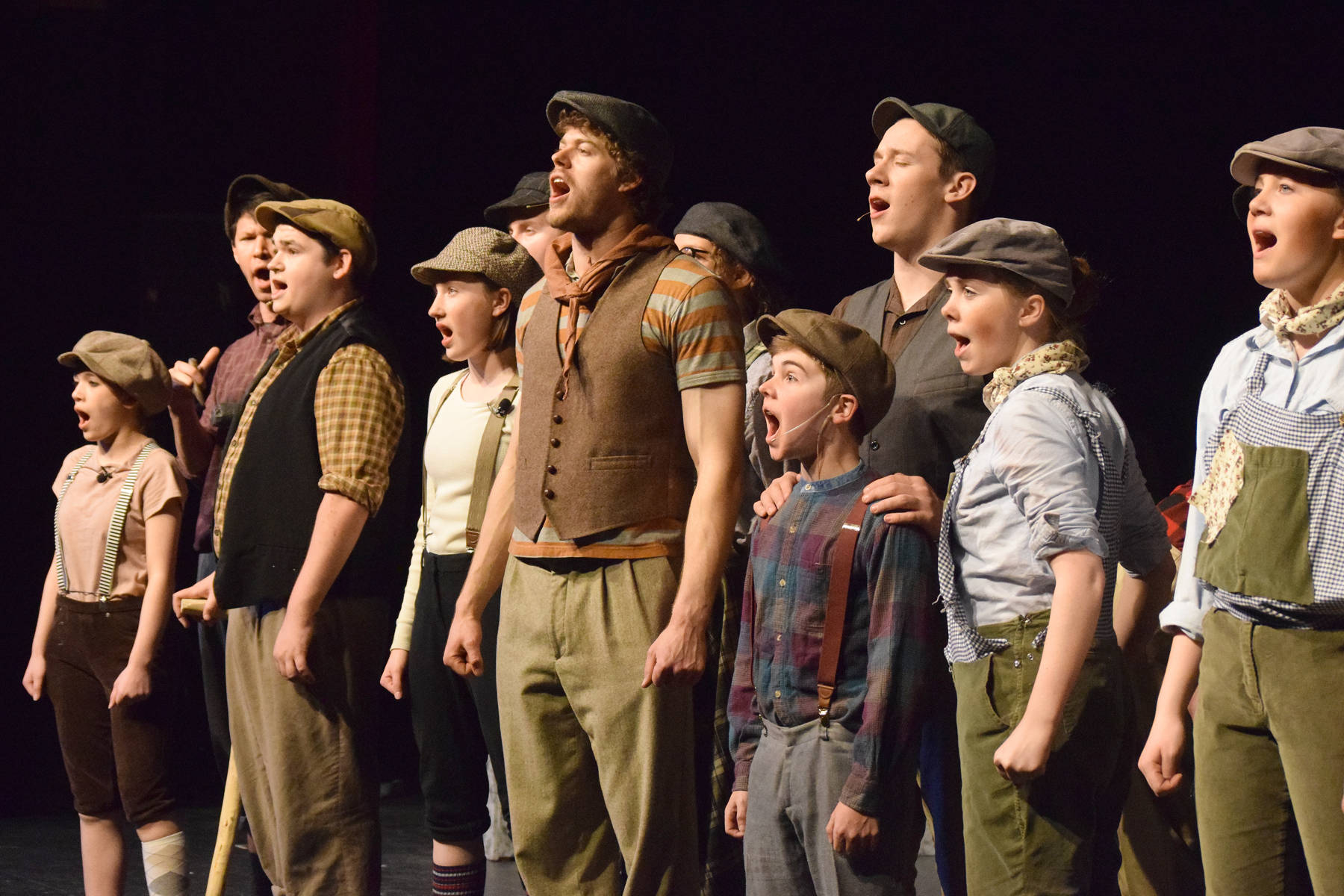 The cast of “Newsies” sings during rehearsal on Wednesday, April 24, 2019, at the Nikiski High School auditorium. (Photo by Joey Klecka/Peninsula Clarion)