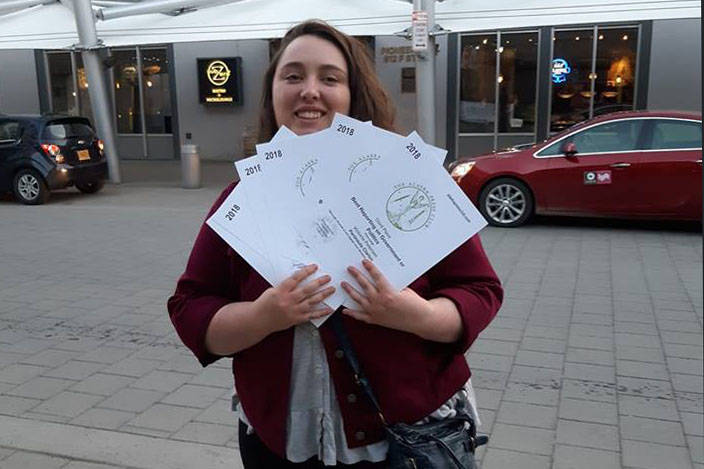 Clarion reporter Victoria Petersen holds Alaska Press Club awards on Saturday, April 27, 2019, in Anchorage, Alaska. (Photo courtesy Victoria Petersen)