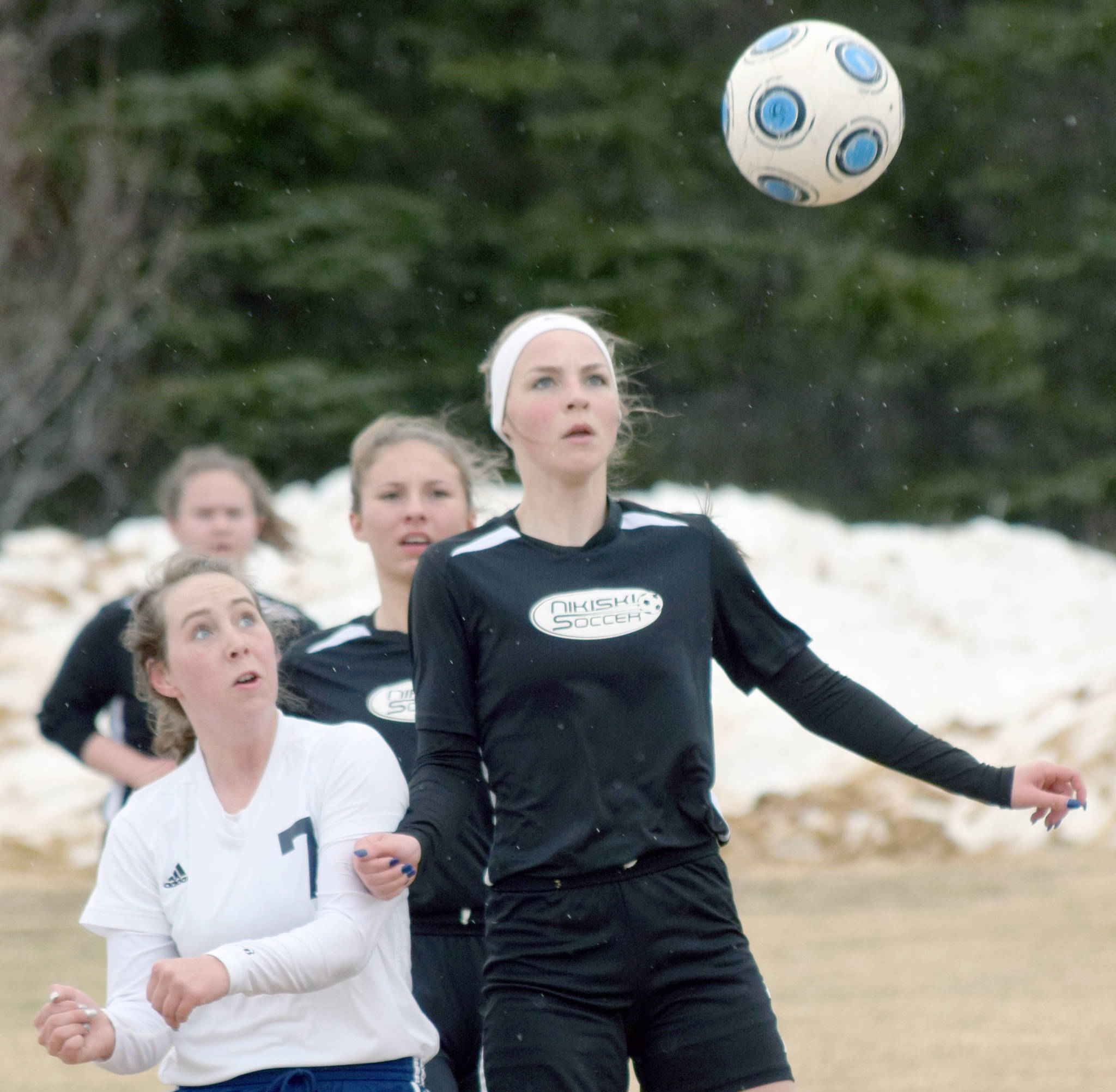 Soldotna’s Journey Miller and Nikiski’s Lillian Carstens battle for the ball on Monday, April 29, 2019, at Nikiski High School in Nikiski, Alaska. (Photo by Jeff Helminiak/Peninsula Clarion)