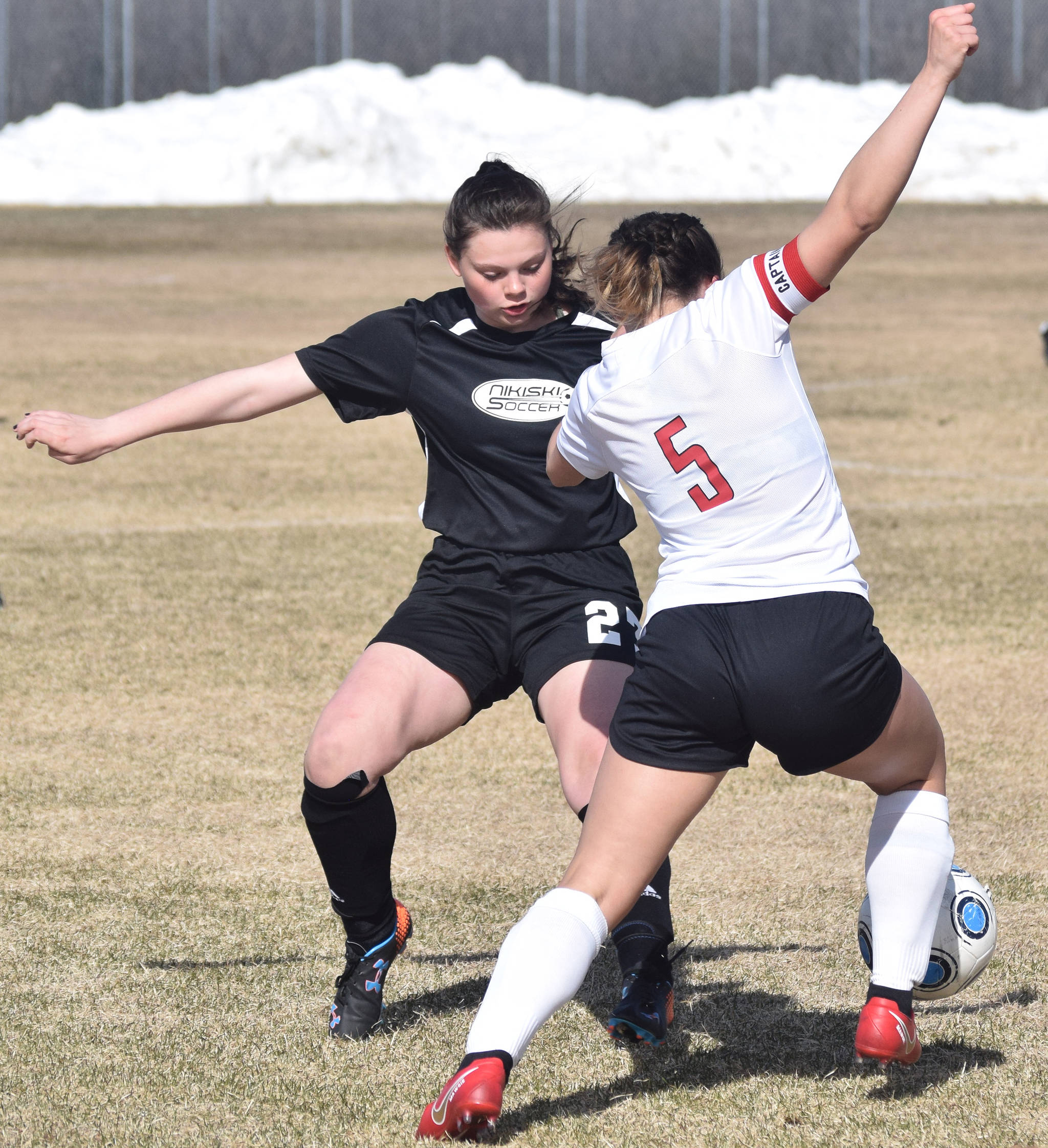 Nikiski’s Tawnisha Freeman (left) goes for a steal of the ball on Kenai’s Alissa Maw in a Peninsula Conference game Tuesday, April 30, 2019, at Nikiski High School. (Photo by Joey Klecka/Peninsula Clarion)