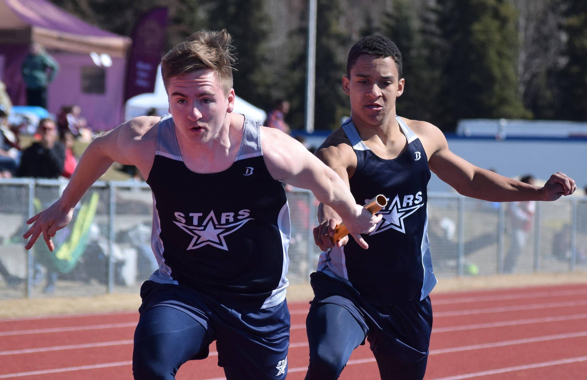 Soldotna junior Ben Booth (right) hands off sophomore teammate Eli Cravens in the boys 800-meter relay Saturday afternoon at the SoHi Region III Preview Invite at Justin Maile Field in Soldotna. (Photo by Joey Klecka/Peninsula Clarion)