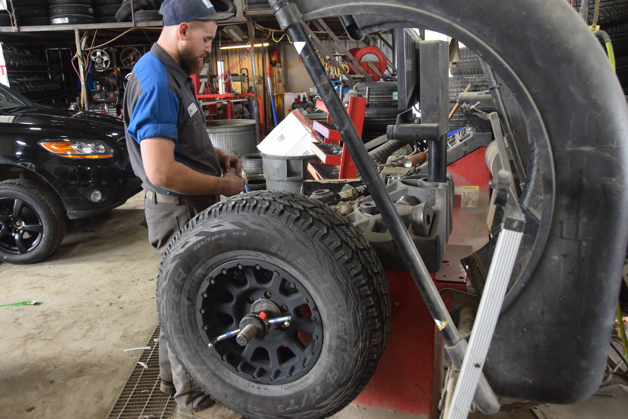 Alyeska Tire employee John Wilson balances a tire at the store in Kenai, Alaska on May 2, 2019. (Photo by Brian Mazurek/Peninsula Clarion)