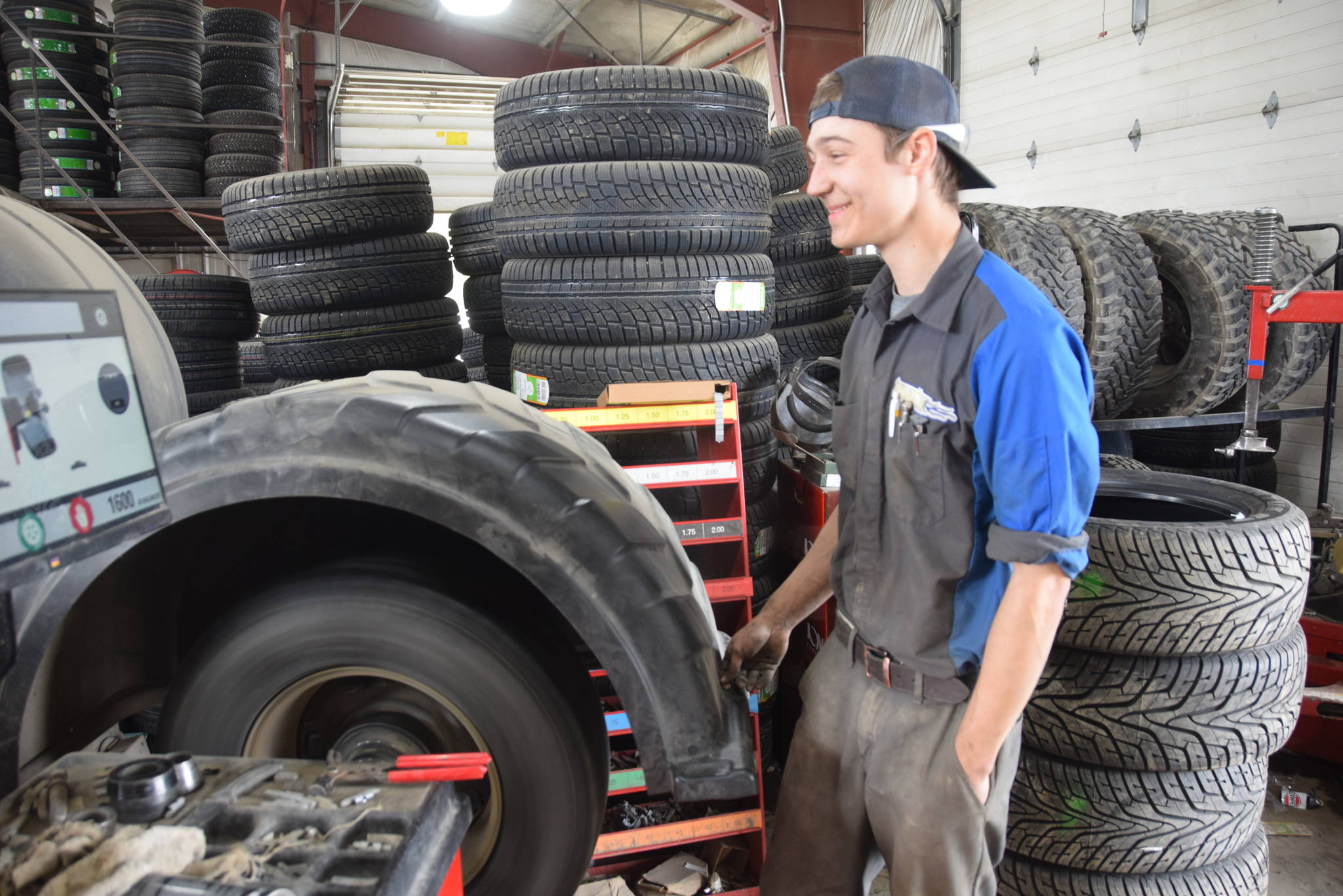 Alyeska Tire employee David Baldwin balances a tire at the location in Kenai, Alaska on May 2, 2019. (Photo by Brian Mazurek)