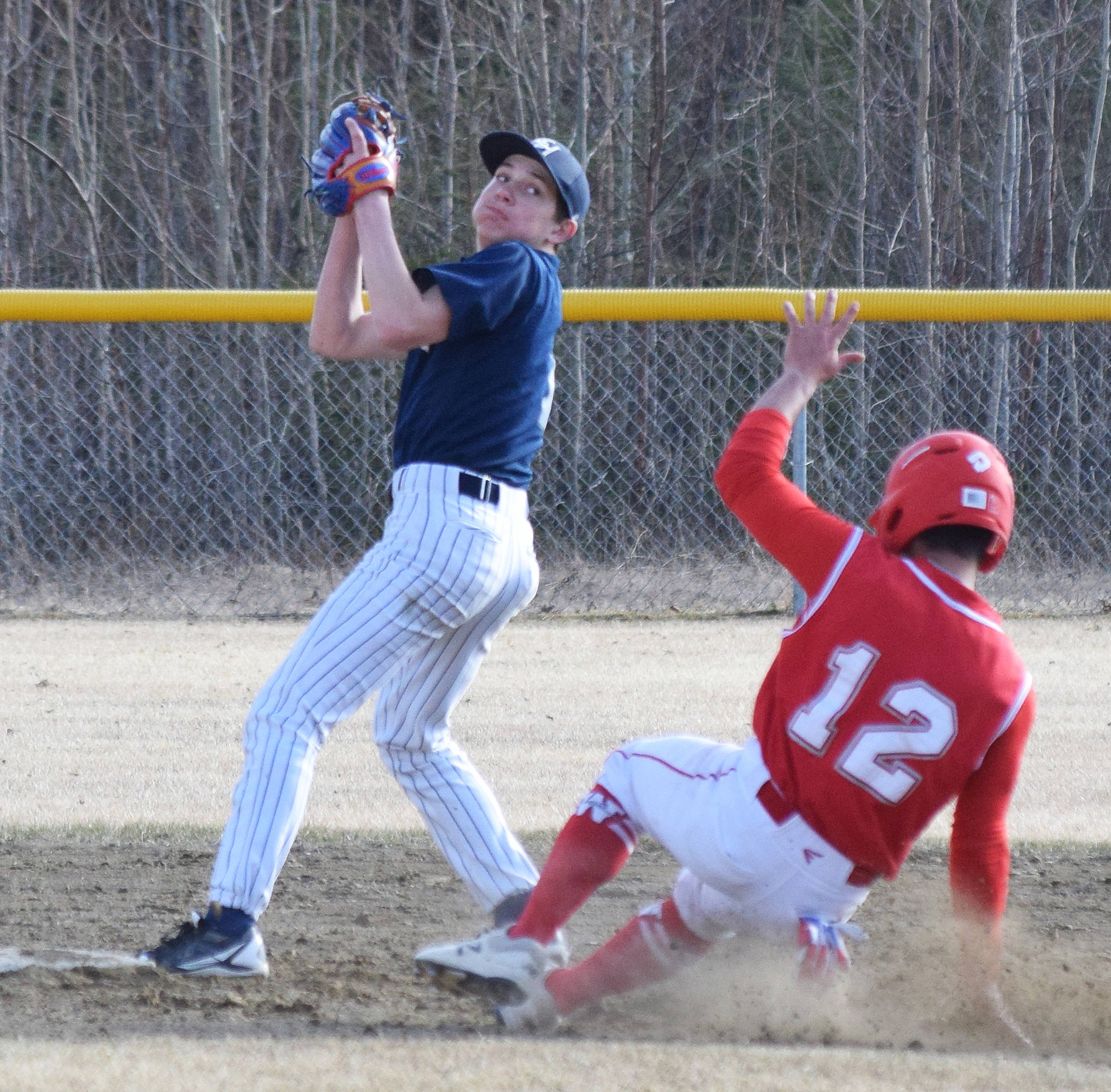 Soldotna second baseman Jacob Belger attempts to turn a double play against Wasilla in a Southcentral Conference contest Thursday, May 2, 2019, at the Soldotna Baseball Fields. (Photo by Joey Klecka/Peninsula Clarion)