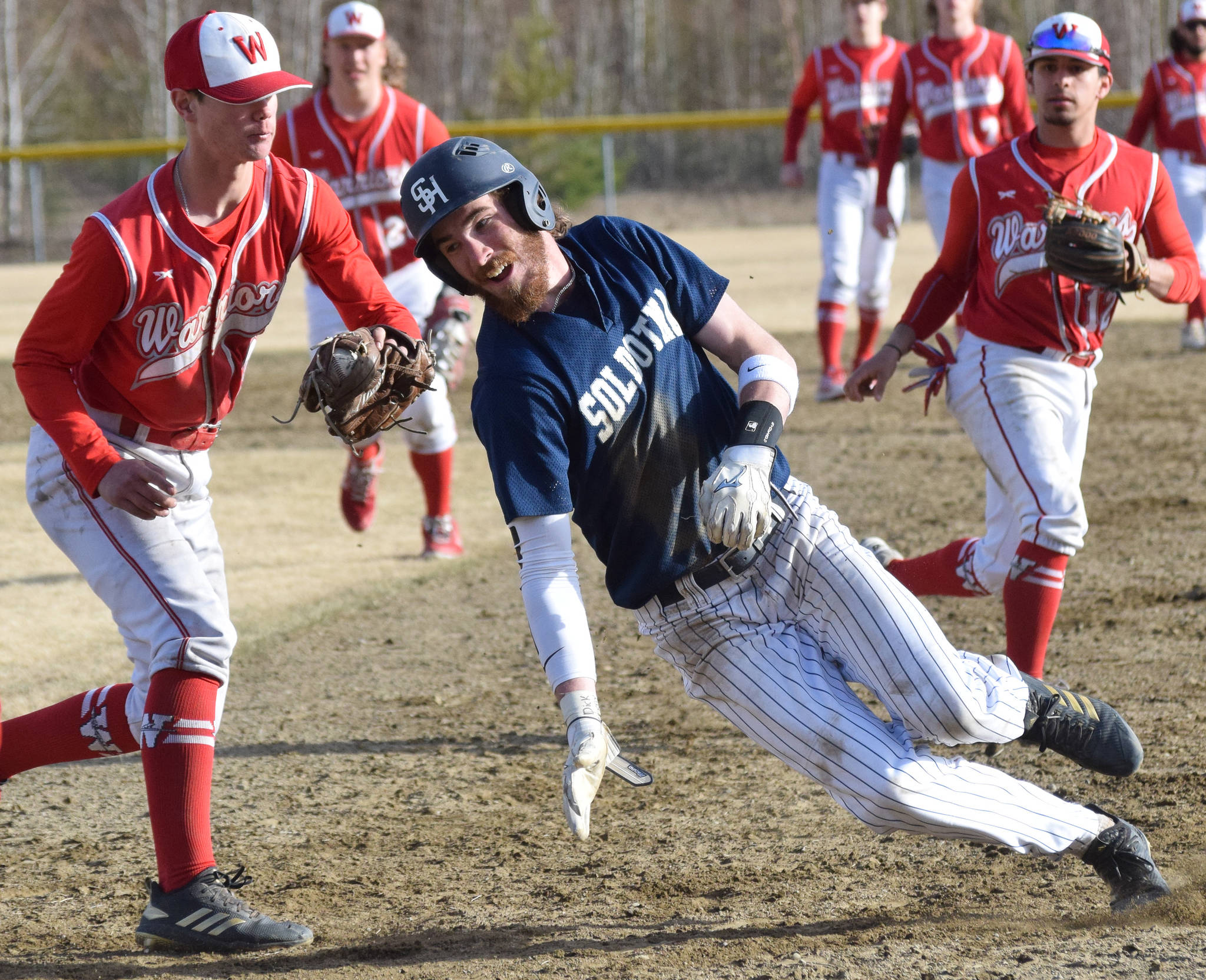 Soldotna’s David Michael (right) attempts to evade the tag of Wasilla’s Clayton Boyett in a Southcentral Conference contest Thursday, May 2, 2019, at the Soldotna Baseball Fields. (Photo by Joey Klecka/Peninsula Clarion)