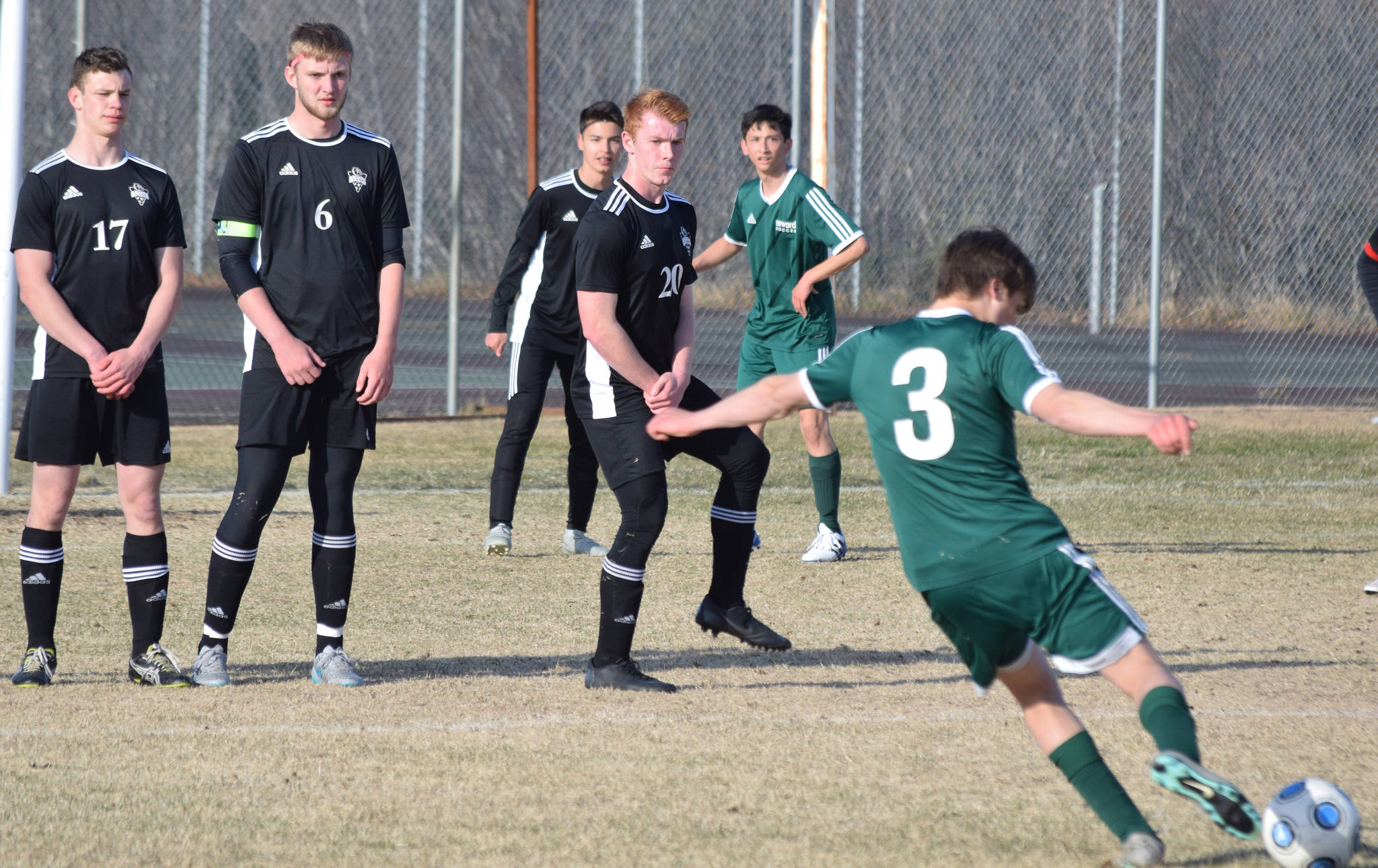Seward’s Samuel Koster fires a free kick towards a wall of Nikiski defenders (L to R, Koleman McCaughey, Cody Handley and Jace Kornstad) Friday afternoon in a Peninsula Conference contest at Nikiski High School. (Photo by Joey Klecka/Peninsula Clarion)