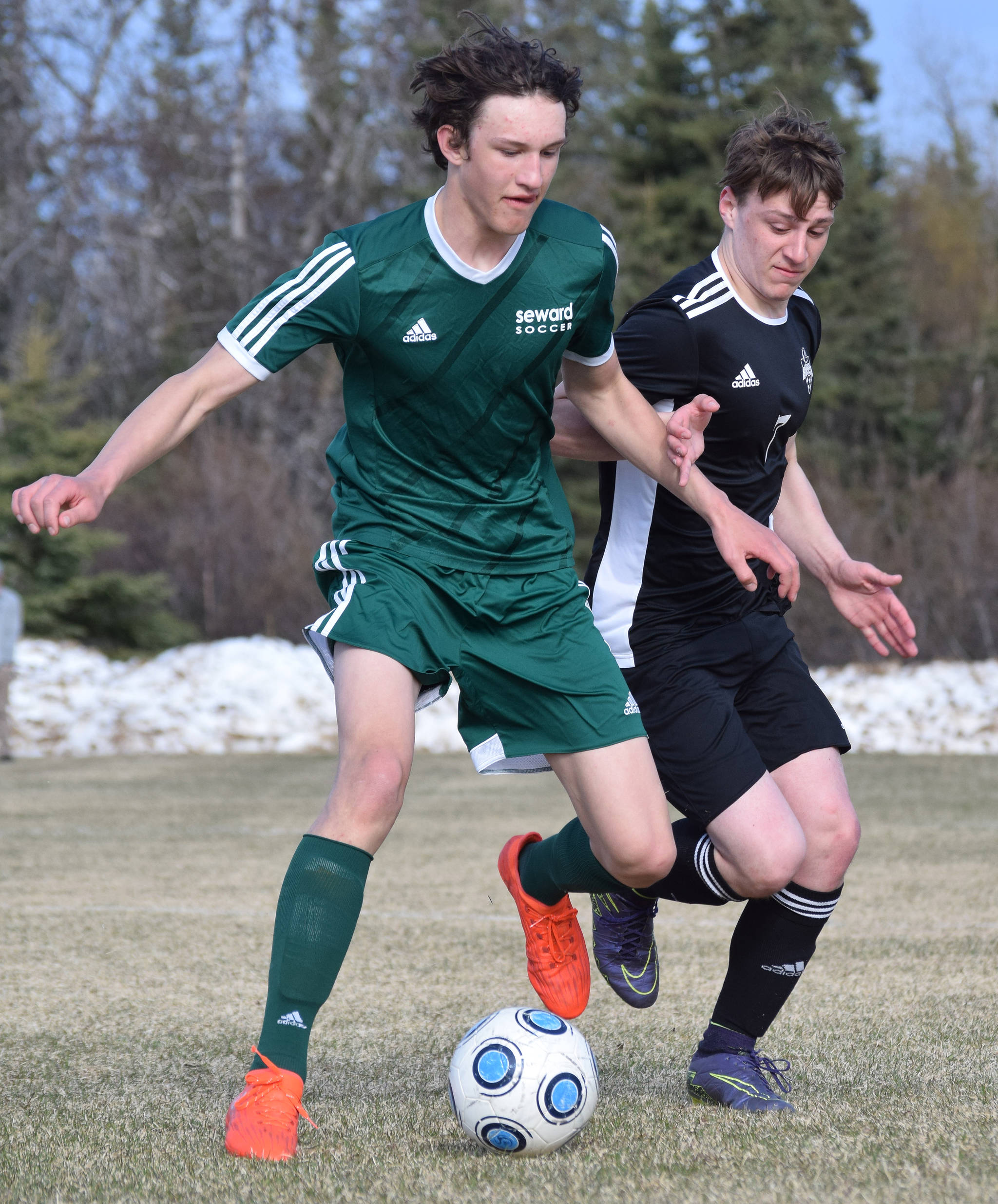Seward’s Bjorn Nilsson (left) and Nikiski’s Justin Harris battle for the ball Friday afternoon in a Peninsula Conference contest at Nikiski High School. (Photo by Joey Klecka/Peninsula Clarion)