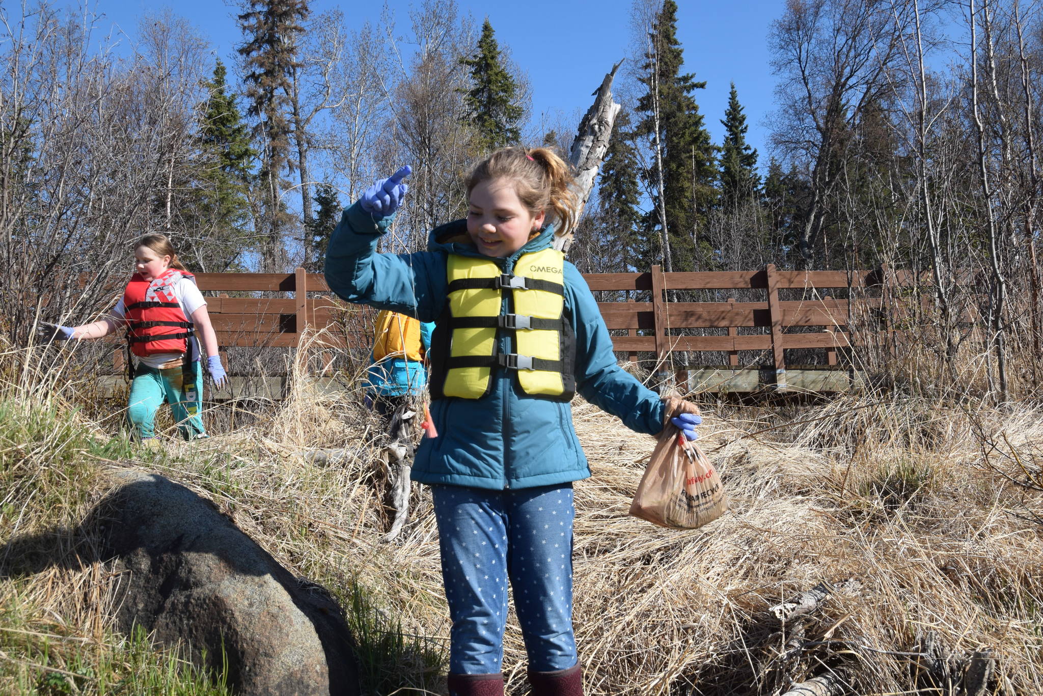 A student from Redoubt Elementary holds up a discarded fishing line and lure during the 6th Annual Kids Kenai River Spring Cleanup at Swiftwater Park in Soldotna, Alaska on May 3, 2019. (Photo by Brian Mazurek/Peninsula Clarion)