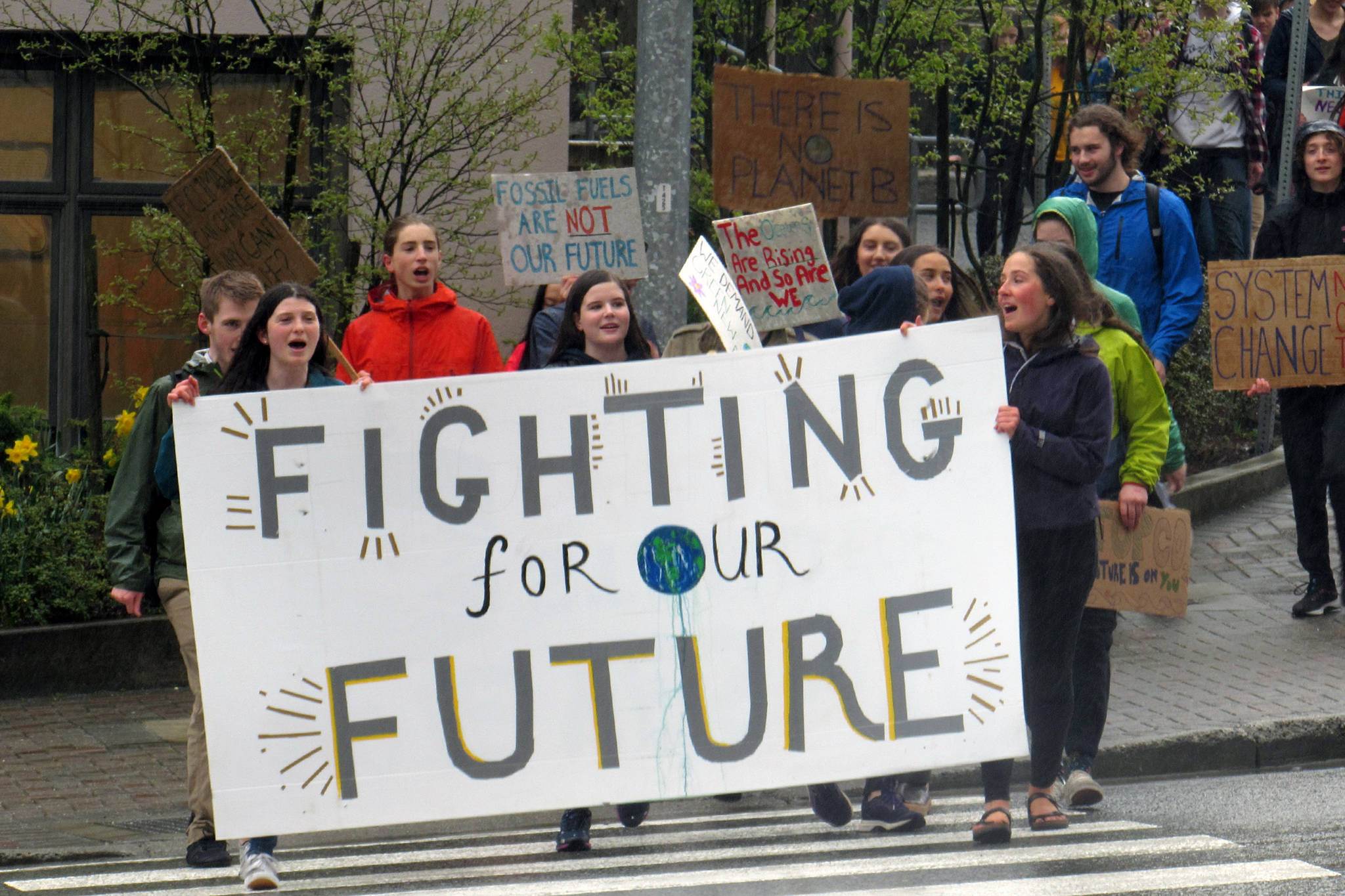 Students march from Juneau-Douglas High School: Yadaa.at Kalé to a climate change rally at the Alaska State Capitol, Friday, May 3, 2019. (Ben Hohenstatt | Juneau Empire)