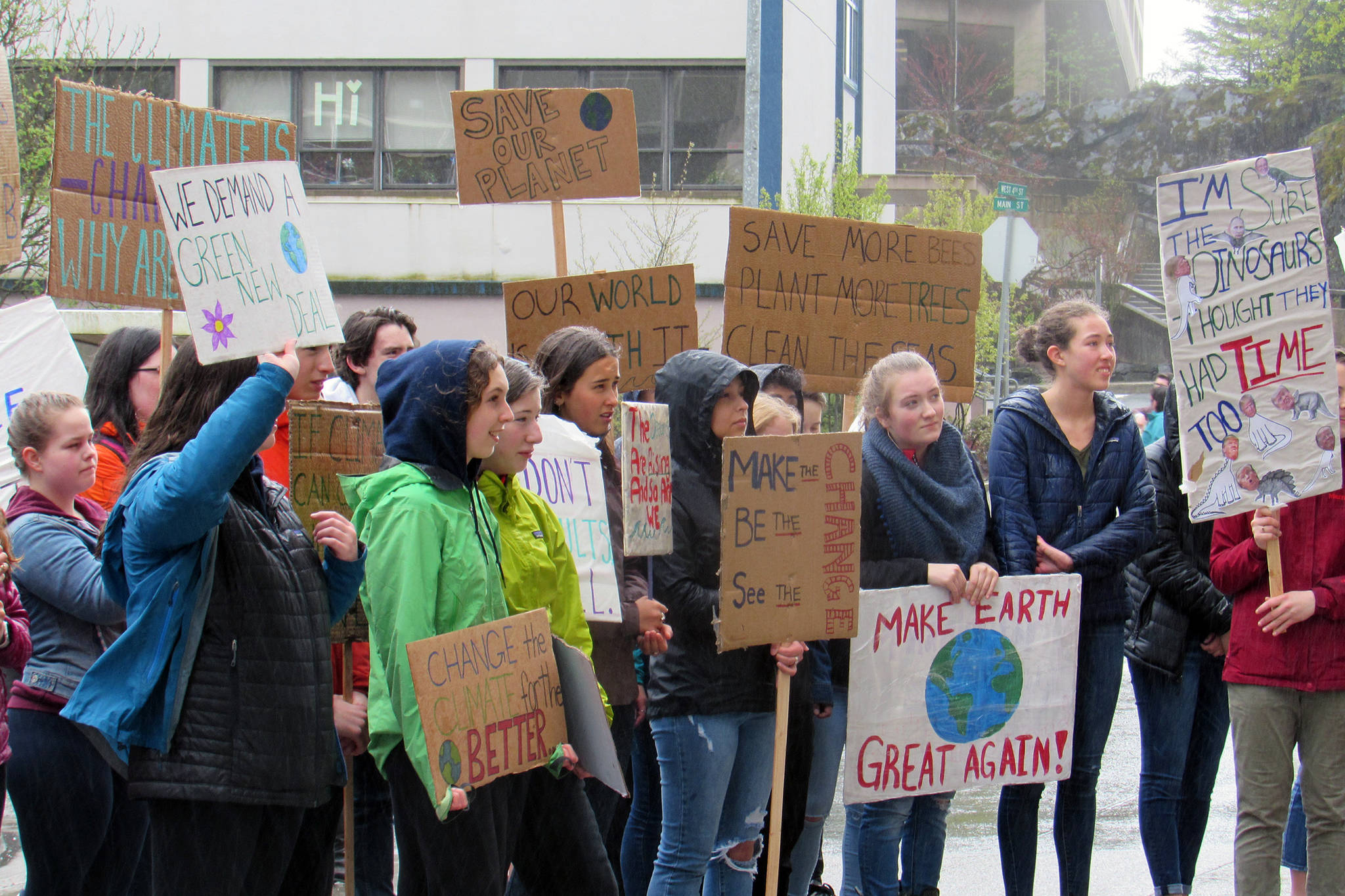 Students hold signs during a climate change rally at the Alaska State Capitol, Friday, May 3, 2019. (Ben Hohenstatt | Juneau Empire)