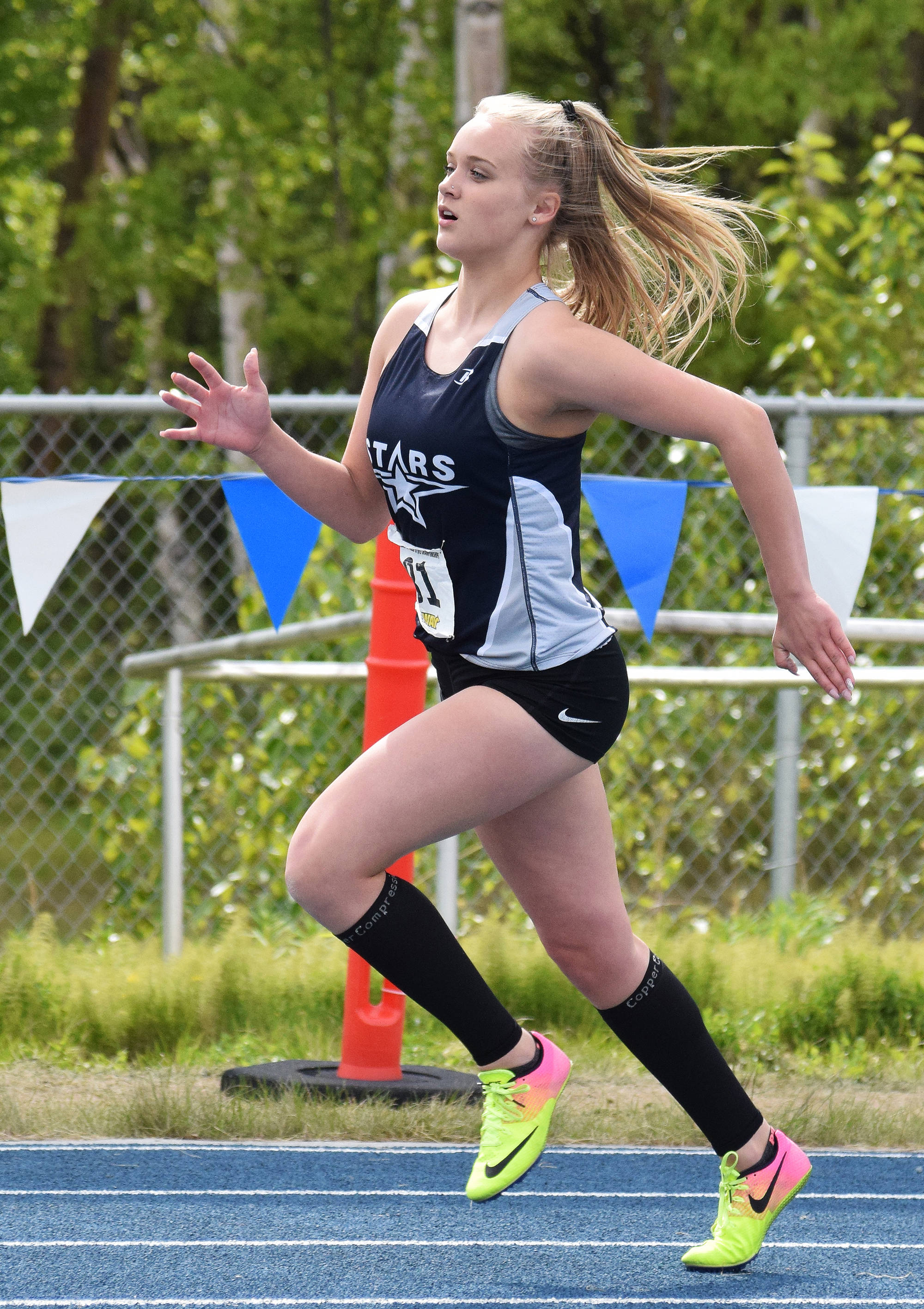 Soldotna’s Brittany Taylor rounds a bend in the Class 4A girls 400-meter dash May 27, 2017, at the Alaska state track & field championships at Palmer High School. (Photo by Joey Klecka/Peninsula Clarion)