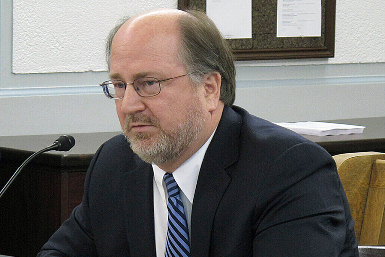 In this Jan. 29, 2019 file photo, Alaska Attorney General Kevin Clarkson testifies before state senators during a confirmation hearing in Juneau, Alaska. Clarkson says his life was likely saved by one simple act. He suspected he was having a heart attack on a flight to Seattle on April 26, 2019, but didn’t want to bother anyone. But a half hour before the plane landed, he pushed the call button for a flight attendant, the likely life-saving event. (AP Photo/Becky Bohrer, File)