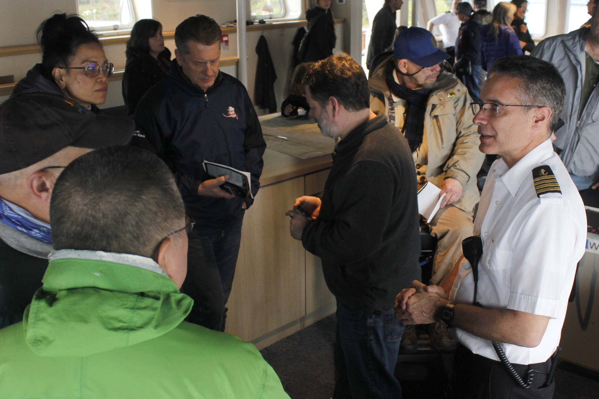 Capt. Michael Schlechter, right, speaks with members of the public on the ferry Tazlina on Sunday, May 5, 2019. (Alex McCarthy | Juneau Empire)