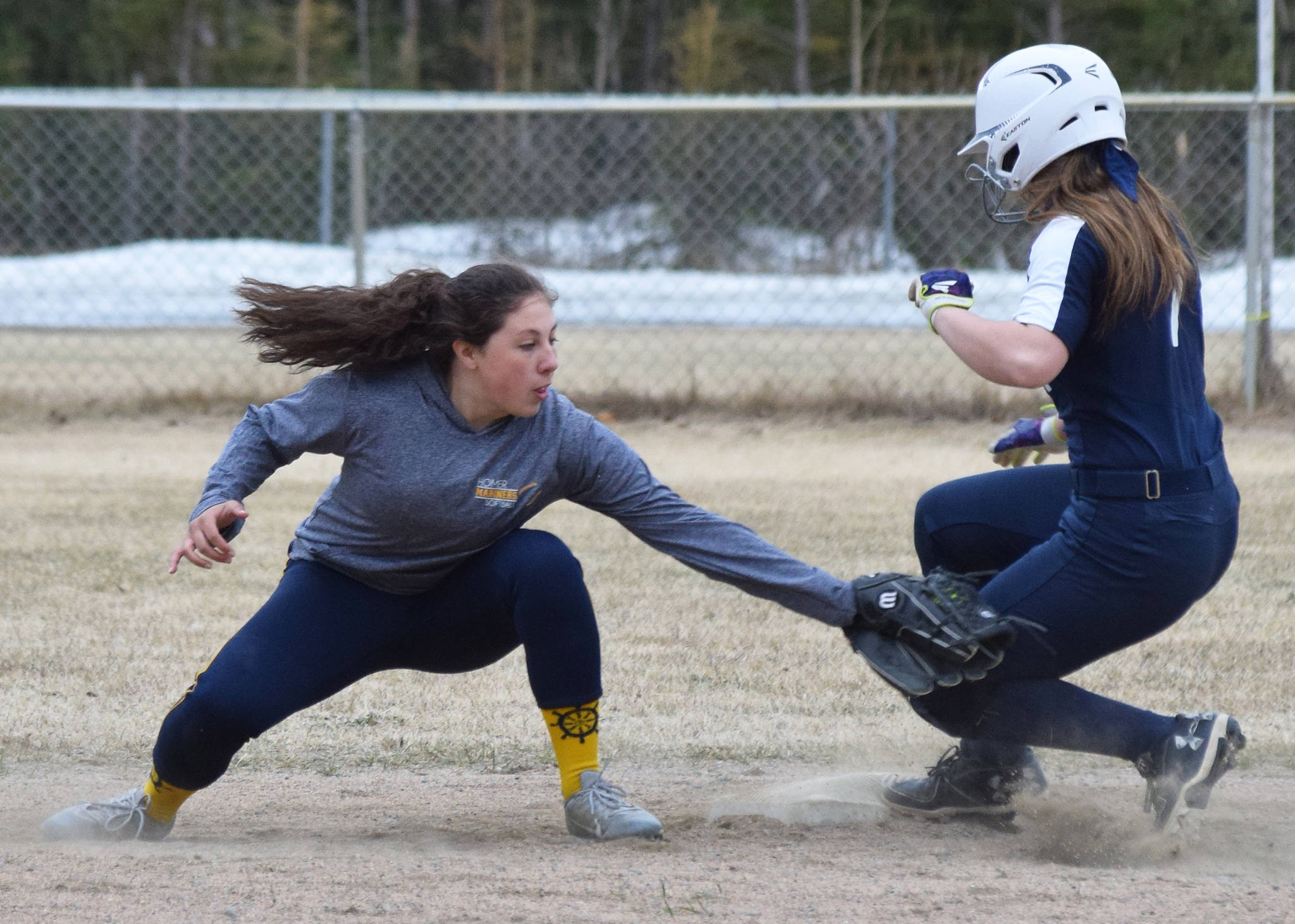 Homer second baseman Hannah Hatfield (left) applies a tag to Soldotna baserunner Casey Earll Tuesday evening in a Northern Lights Conference game in Soldotna. (Photo by Joey Klecka/Peninsula Clarion)