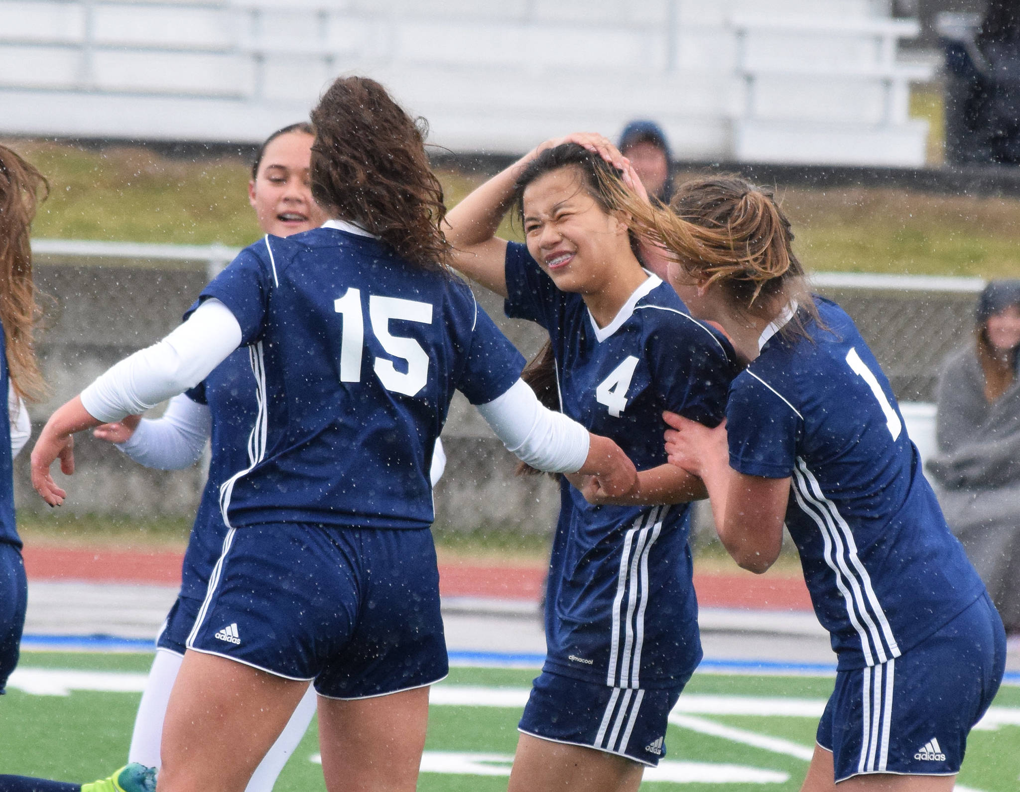 Soldotna’s Meijan Leaf (4) receives congratulations from teammates after scoring a goal against Homer Saturday, May 11, 2019, in a Peninsula Conference game in Soldotna, Alaska. (Photo by Joey Klecka/Peninsula Clarion)