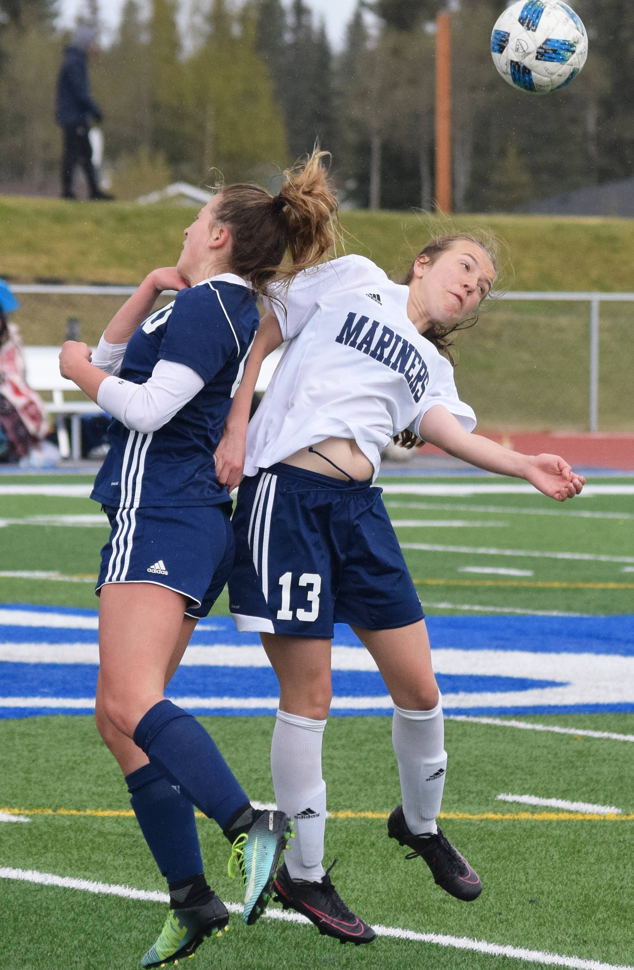 Homer’s Kappa Reutov (13) and Soldotna’s Ryann Cannava jump up for a header Saturday, May 11, 2019, in a Peninsula Conference game in Soldotna, Alaska. (Photo by Joey Klecka/Peninsula Clarion)