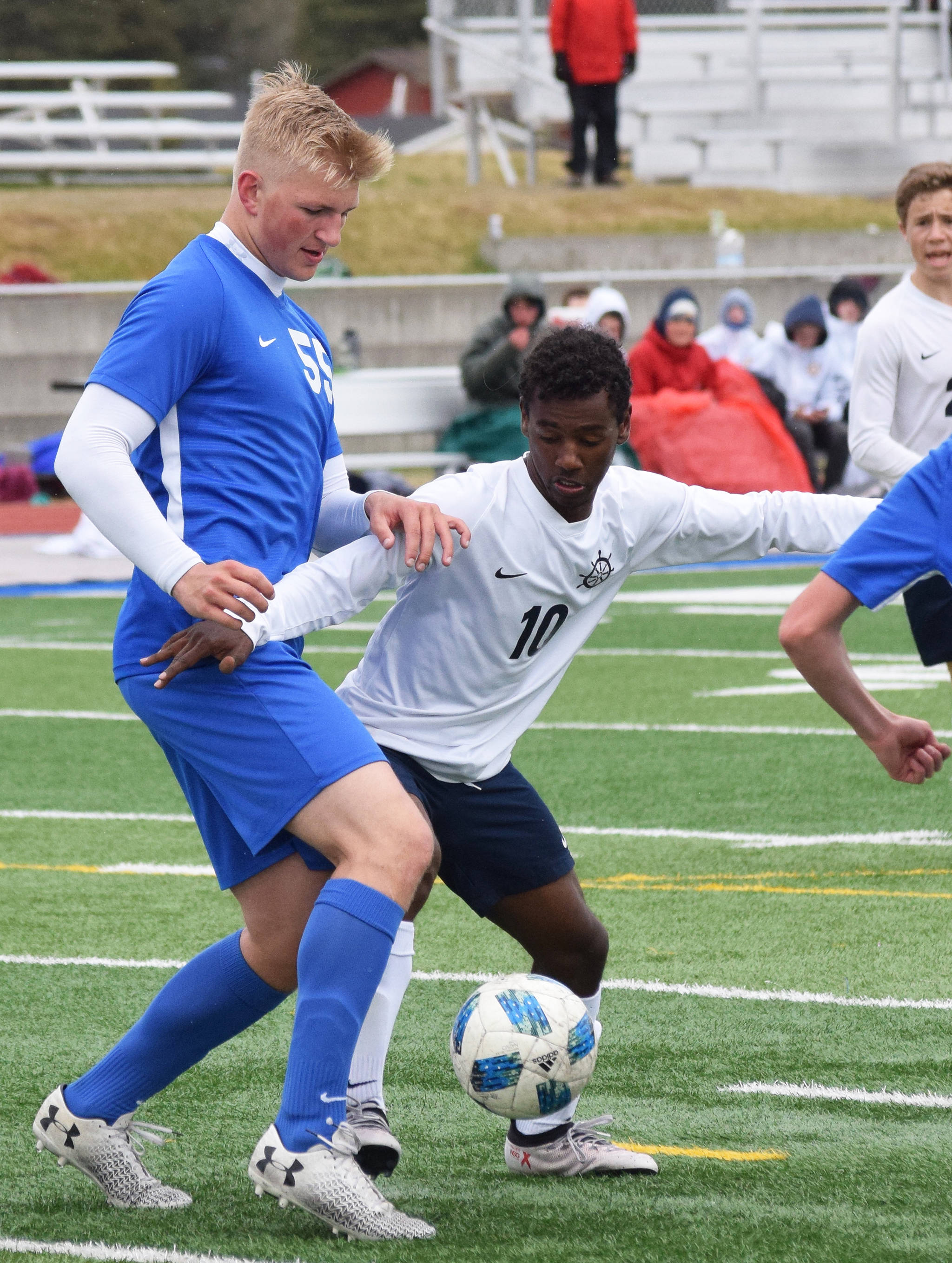 Soldotna’s Hudson Metcalf (left) and Homer’s Eyoab Knapp battle for the ball Saturday, May 11, 2019, in a Peninsula Conference game in Soldotna, Alaska. (Photo by Joey Klecka/Peninsula Clarion)