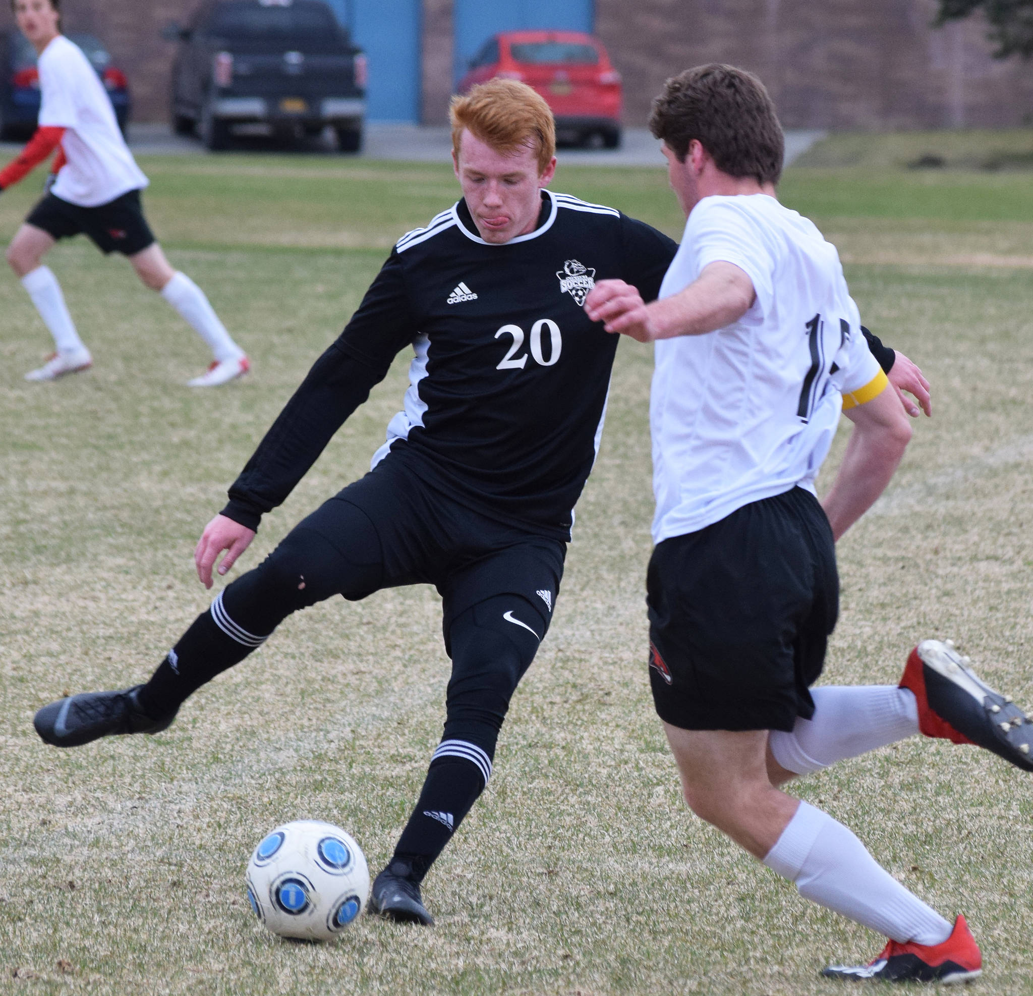 Nikiski’s Jace Kornstad (20) makes a play on the ball in front of Houston’s Owen Mulhaney Friday, May 10, 2019, in a nonconference game in Nikiski, Alaska. (Photo by Joey Klecka/Peninsula Clarion)