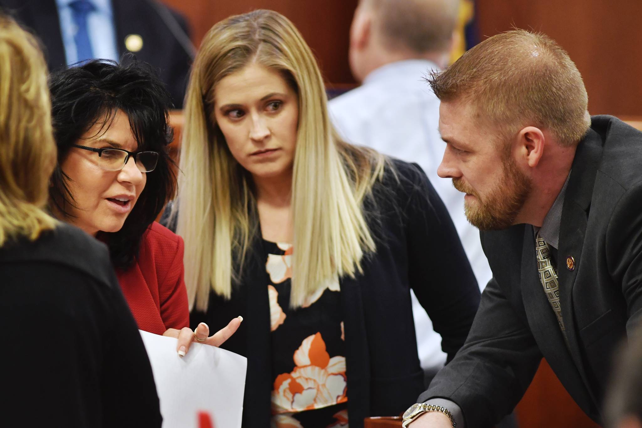 Rep. Cathy Tilton, R-Wasilla, left, speaks with Rep. Sara Rasmussen, R-Anchorage, and Rep. Josh Revak, R-Anchorage, on the House floor as amendments to the budget are proposed on Tuesday, April 9, 2019. (Michael Penn | Juneau Empire)