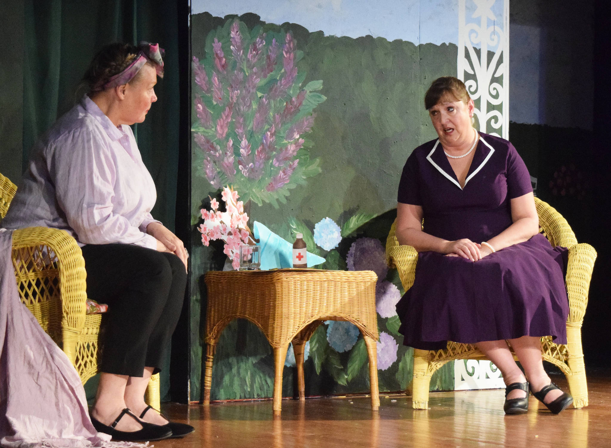 Donna Shirnberg (right) acts out a scene of Sabrina Fair with Terry Zopf-Schoessler during rehearsal Tuesday, May 14, 2019, at Triumvirate North Theater in Kenai, Alaska. (Photo by Joey Klecka/Peninsula Clarion)