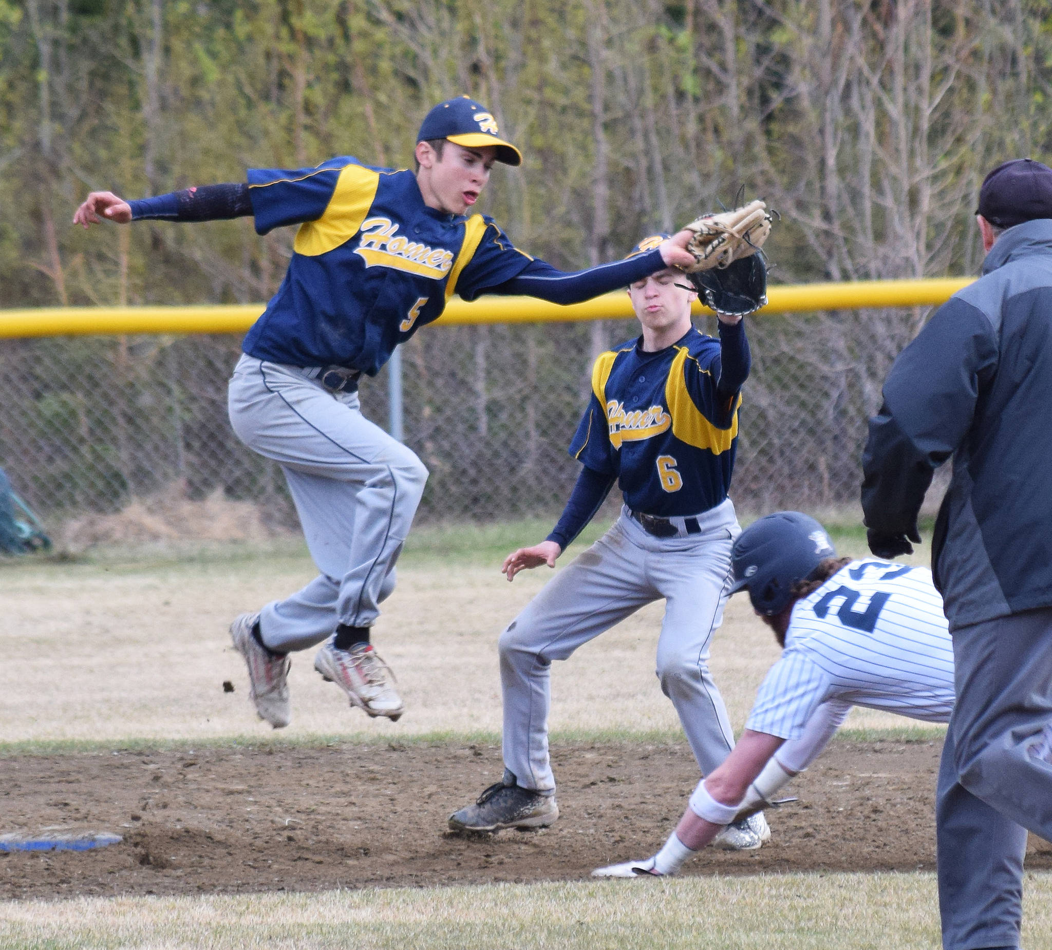 Homer’s Austin Ceccerelli (left) attempts to catch Soldotna’s David Michael stealing second base Wednesday, May 15, 2019, at the Soldotna Little League Fields in Soldotna, Alaska. (Photo by Joey Klecka/Peninsula Clarion)