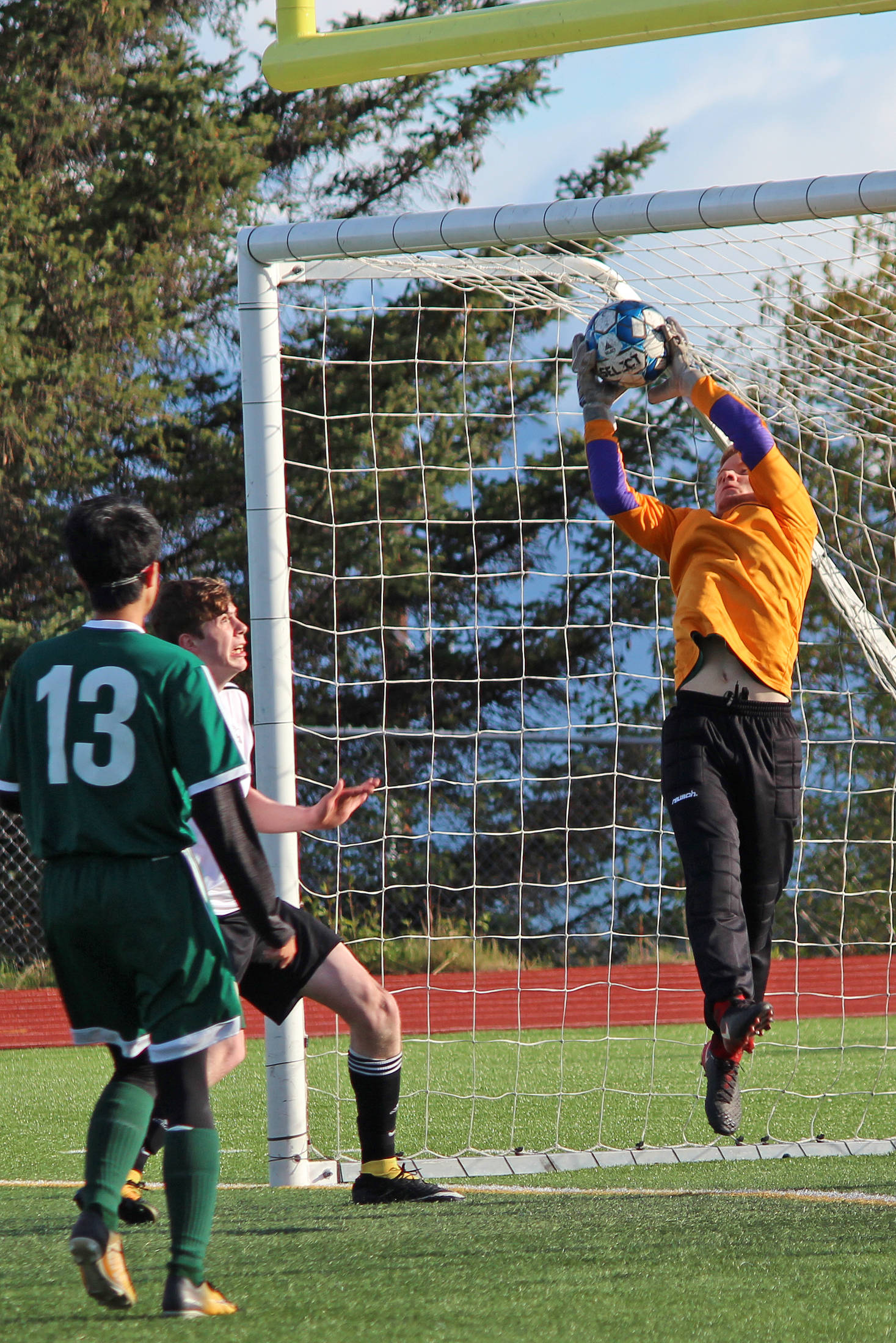 Seward goalkeeper Collin Mullaly snags the ball out of the air during a matchup between the Seahawks and Nikiski on Thursday, May 16, 2019 for the Peninsula Conference Soccer Tournament at Homer High School in Homer, Alaska. (Photo by Megan Pacer/Homer News)