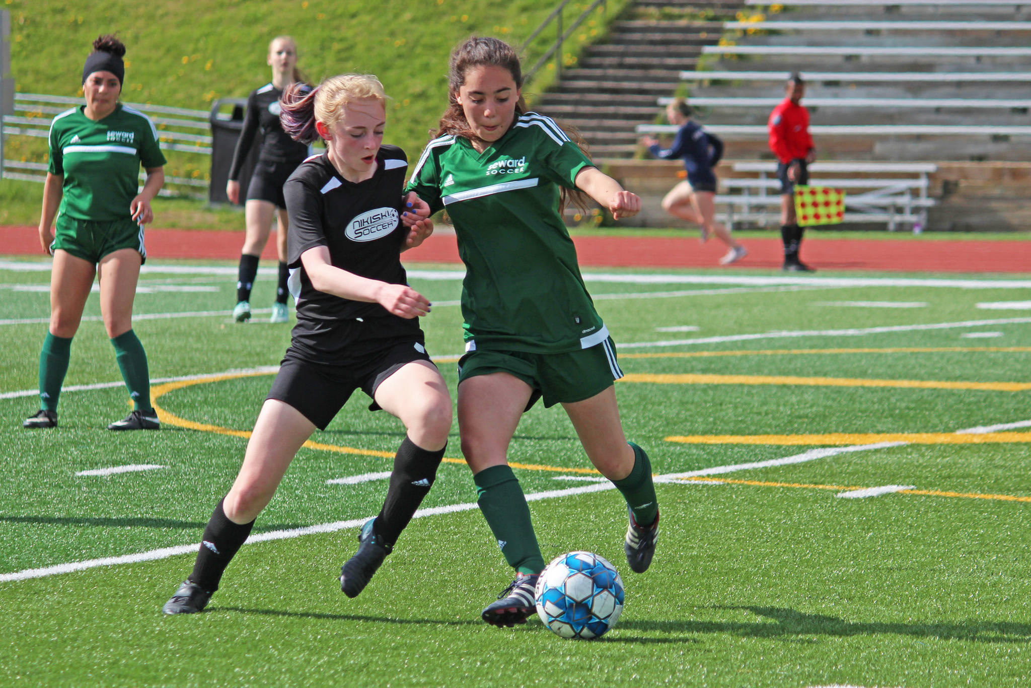 Nikiski’s Cailin Yeager (left) and Seward’s Belladonna Darby (right) battle for the ball during the first girls game of the Peninsula Conference Soccer Tournament on Thursday, May 16, 2019 at Homer High School in Homer, Alaska. (Photo by Megan Pacer/Homer News)