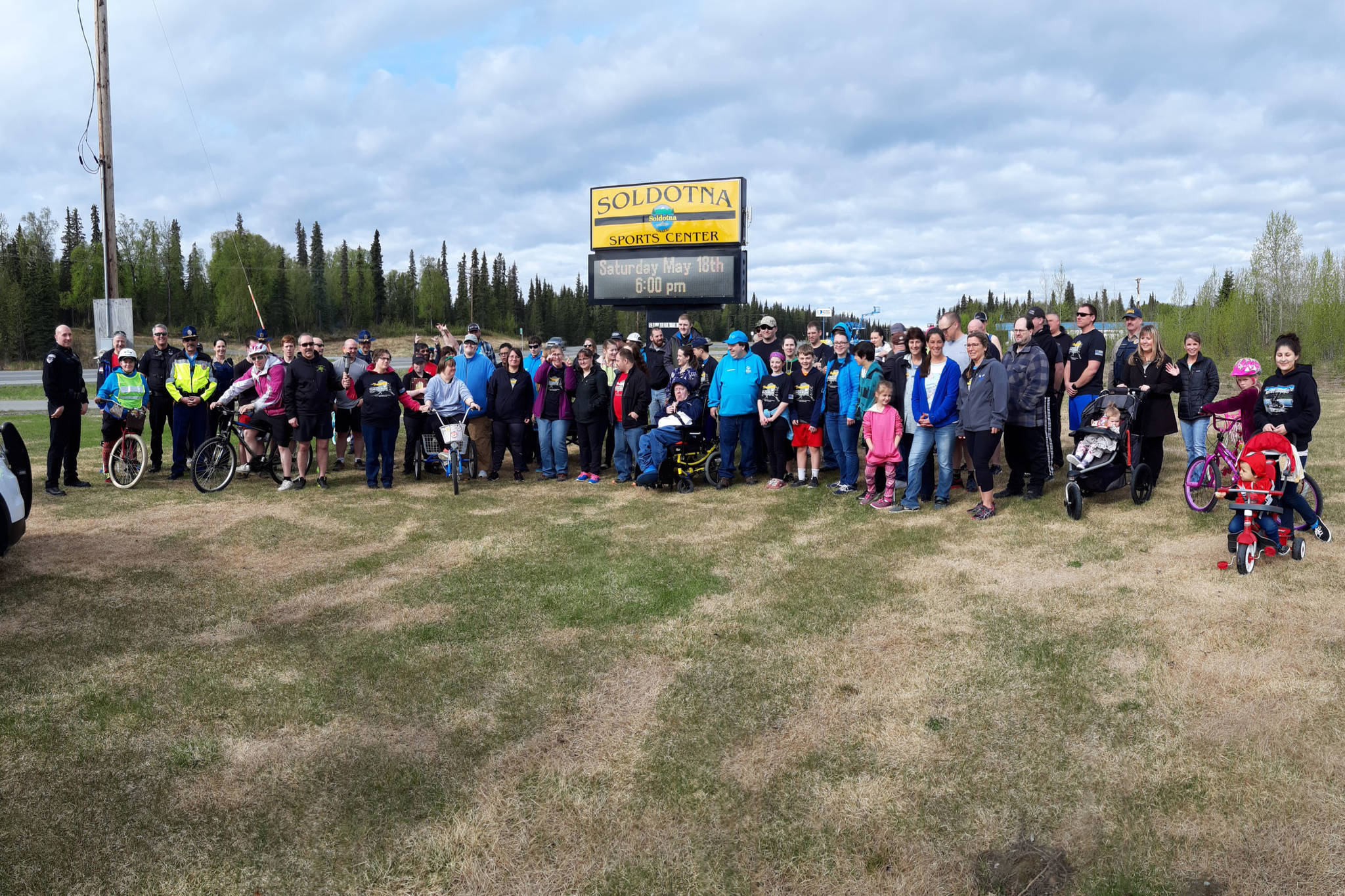 Participants for the annual Special Olympics Torch Run pose for a group photo outside the Soldotna Regional Sports Complex in Soldotna, Alaska on May 18, 2019. (Photo by Brian Mazurek/Peninsula Clarion)