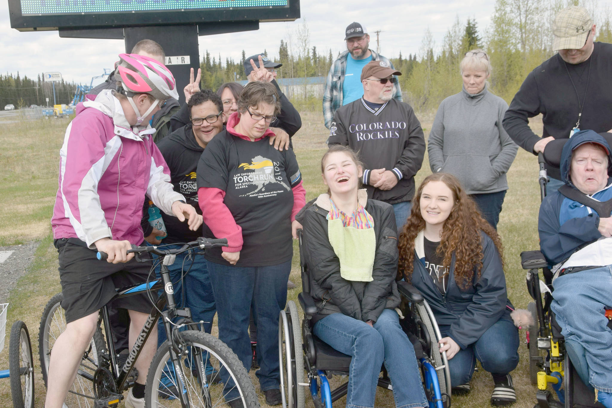 Participants in the annual Special Olympics Torch Run smile for a photo outside the Soldotna Regional Sports Complex in Soldotna Alaska on May 18, 2019. (Photo by Brian Mazurek/Peninsula Clarion)