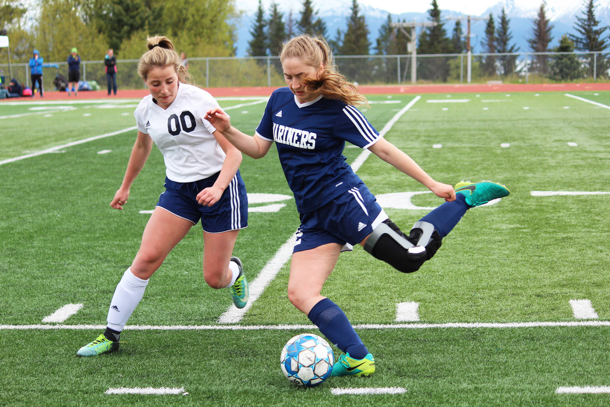 Homer’s Brenna McCarron (right) prepares to send the ball up the field under pressure from Soldotna’s Ryann Cannava during the girls championship game of the Peninsula Conference soccer tournament on Saturday at Homer High School in Homer. (Photo by Megan Pacer/Homer News)
