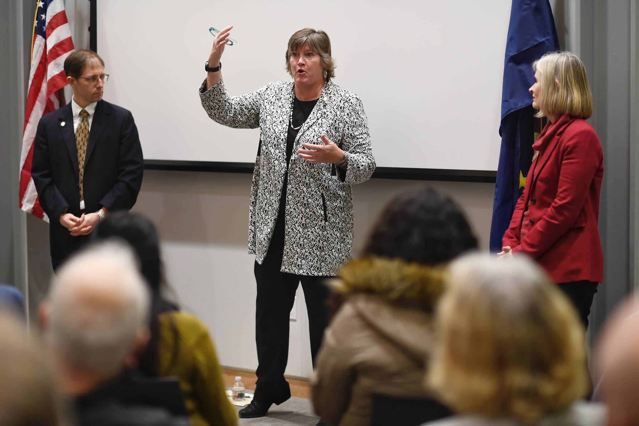 Rep. Sara Hannan, D-Juneau, center, answers a question as Sen. Jesse Kiehl, D-Juneau, left, and Rep. Andi Story, D-Juneau, wait their turn during a standing-room only town hall meeting at the Mendenhall Valley Public Library on Tuesday, Jan. 29, 2019. (Michael Penn | Juneau Empire)